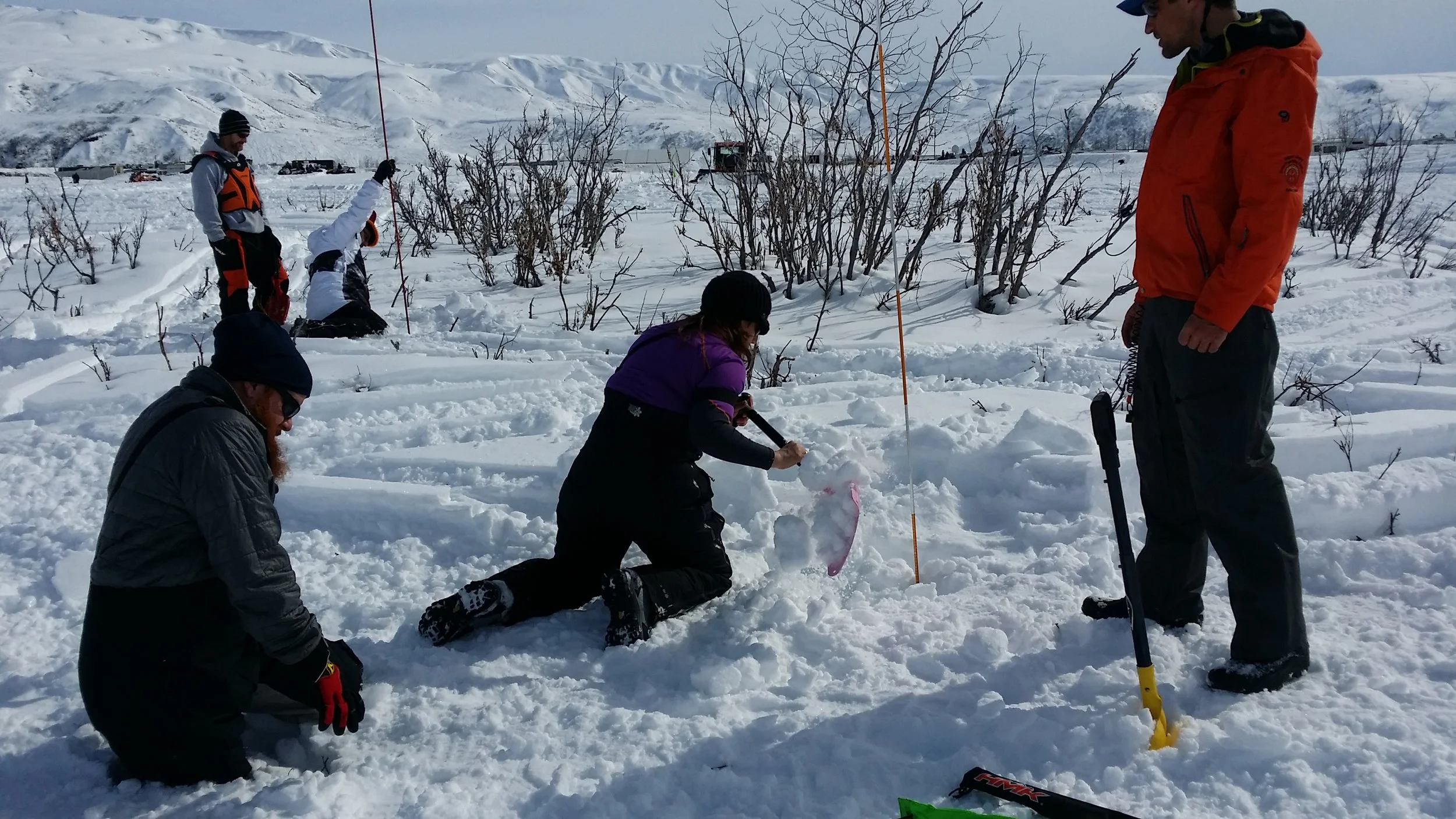  A group of riders take time to practice avalanche rescue at Arctic Man. 