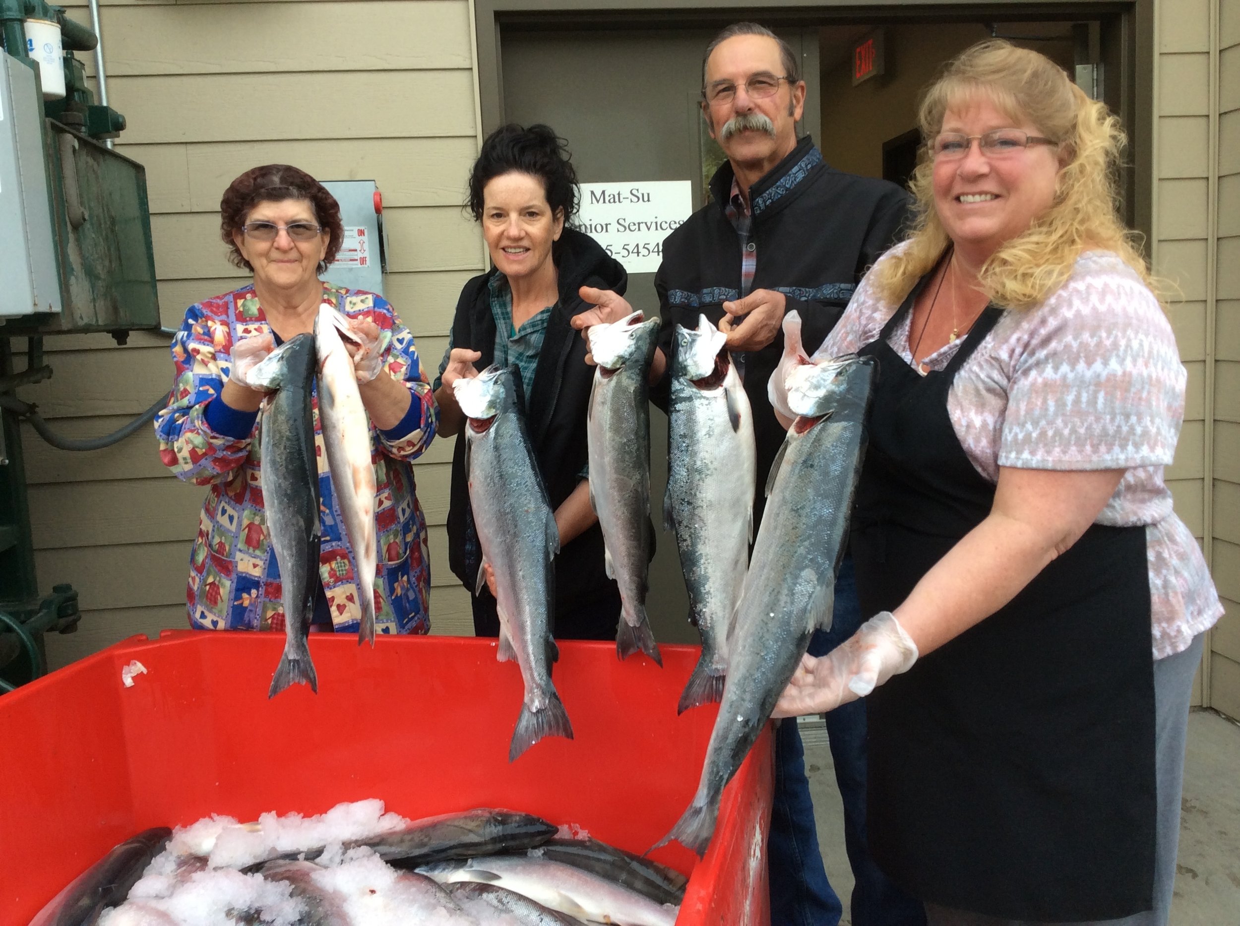   Viewing tote of silver salmon, from left chef Phyllis Moore, Northern Setnetter Page Herring, MSSS Facilities Manager Lowell Burgett and ChoreRespite Manager Beth Westland.  