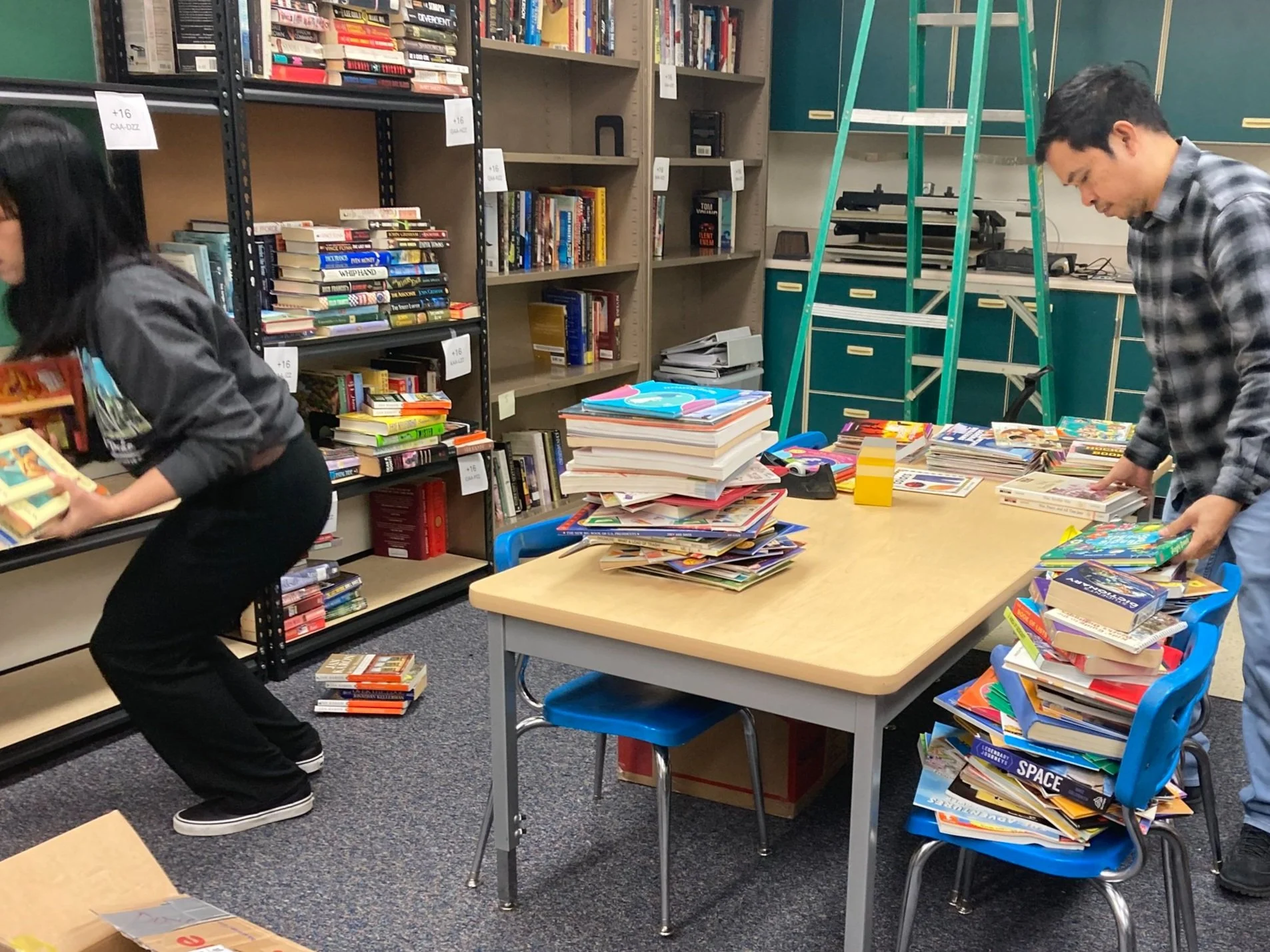   LuAnn and Nat stock the shelves  