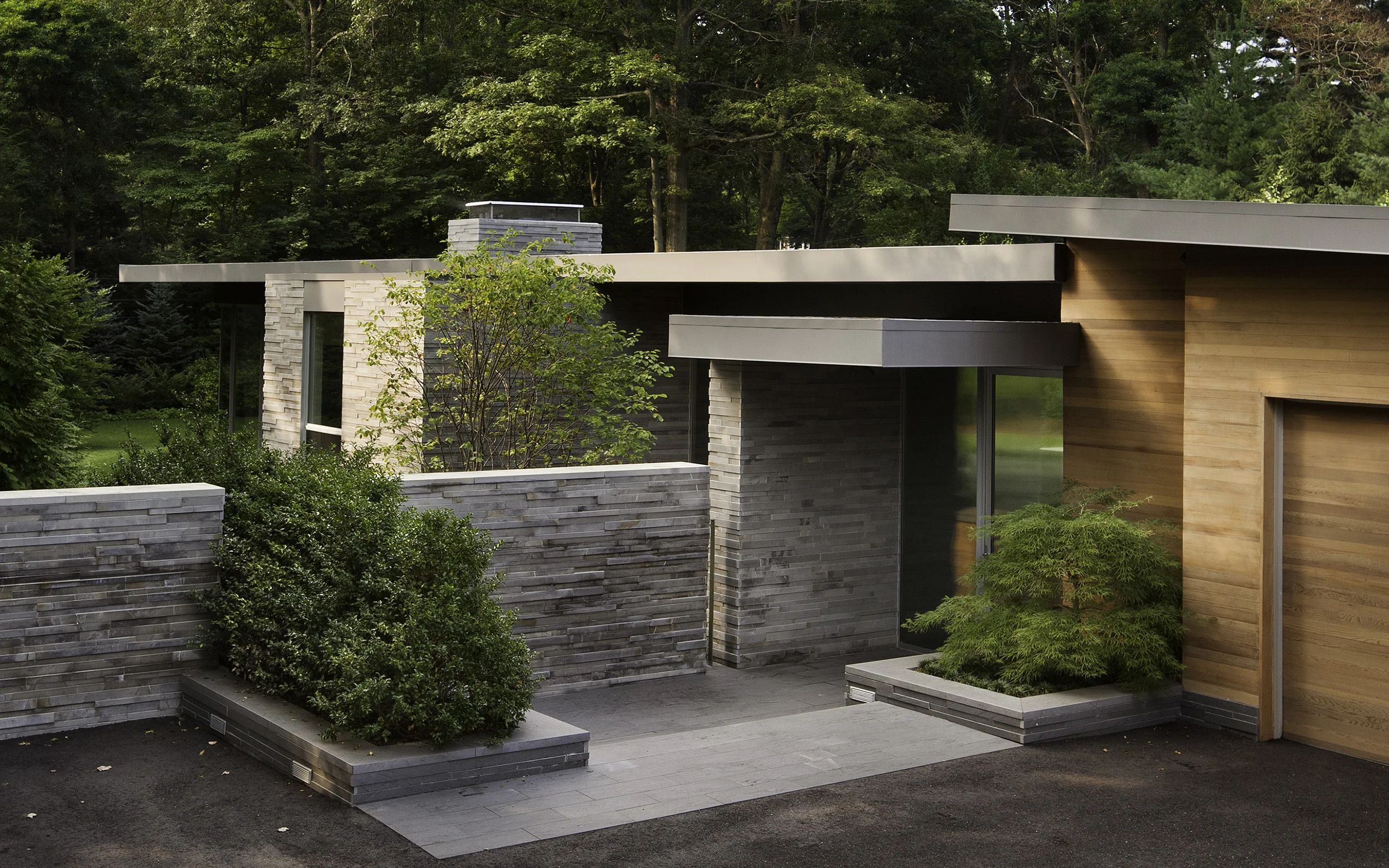 Entry with Cedar-Clad Original House meeting Stone and Glass Pavilion