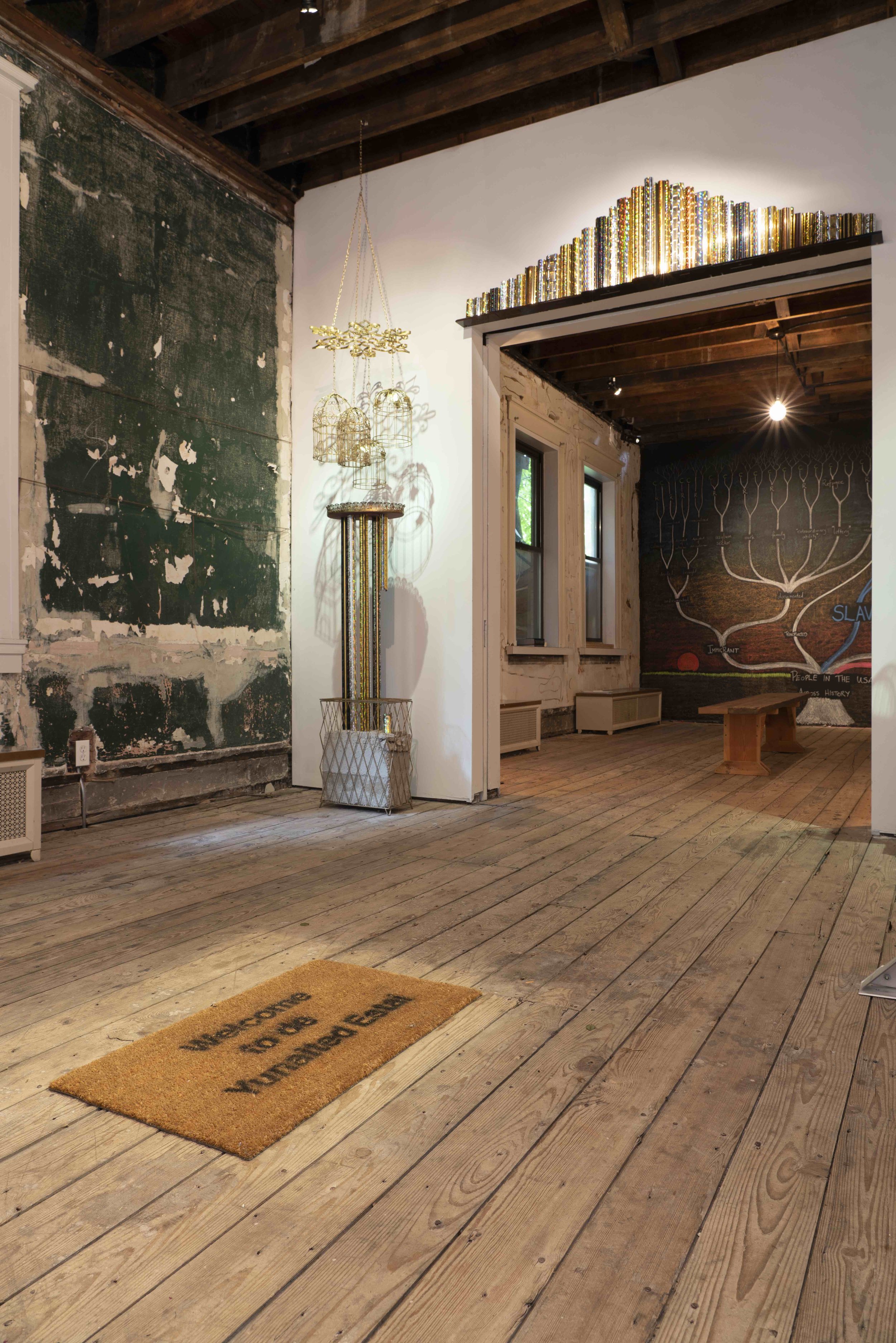   Welcome to the yunaited estai  by Esperanza Mayobre (foreground);  The Promise  by Benjamin Larose (middle),  Sunset on the American Dream  by Eugenia Cheng (background) 