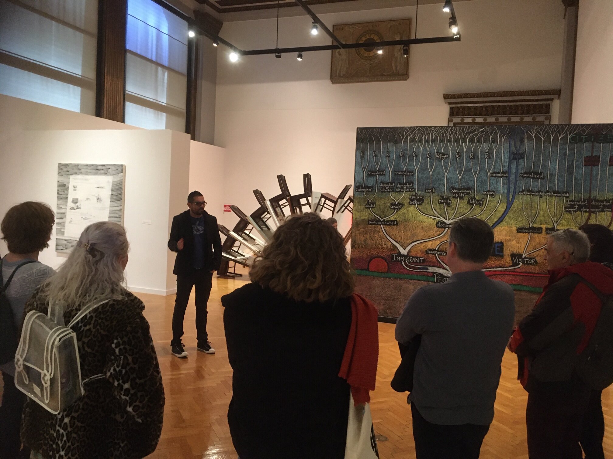  Rodrigo Lara Zendejas leading a tour of  In Flux: Chicago Artists and Immigration  at Chicago Cultural Center in early March 2020. 