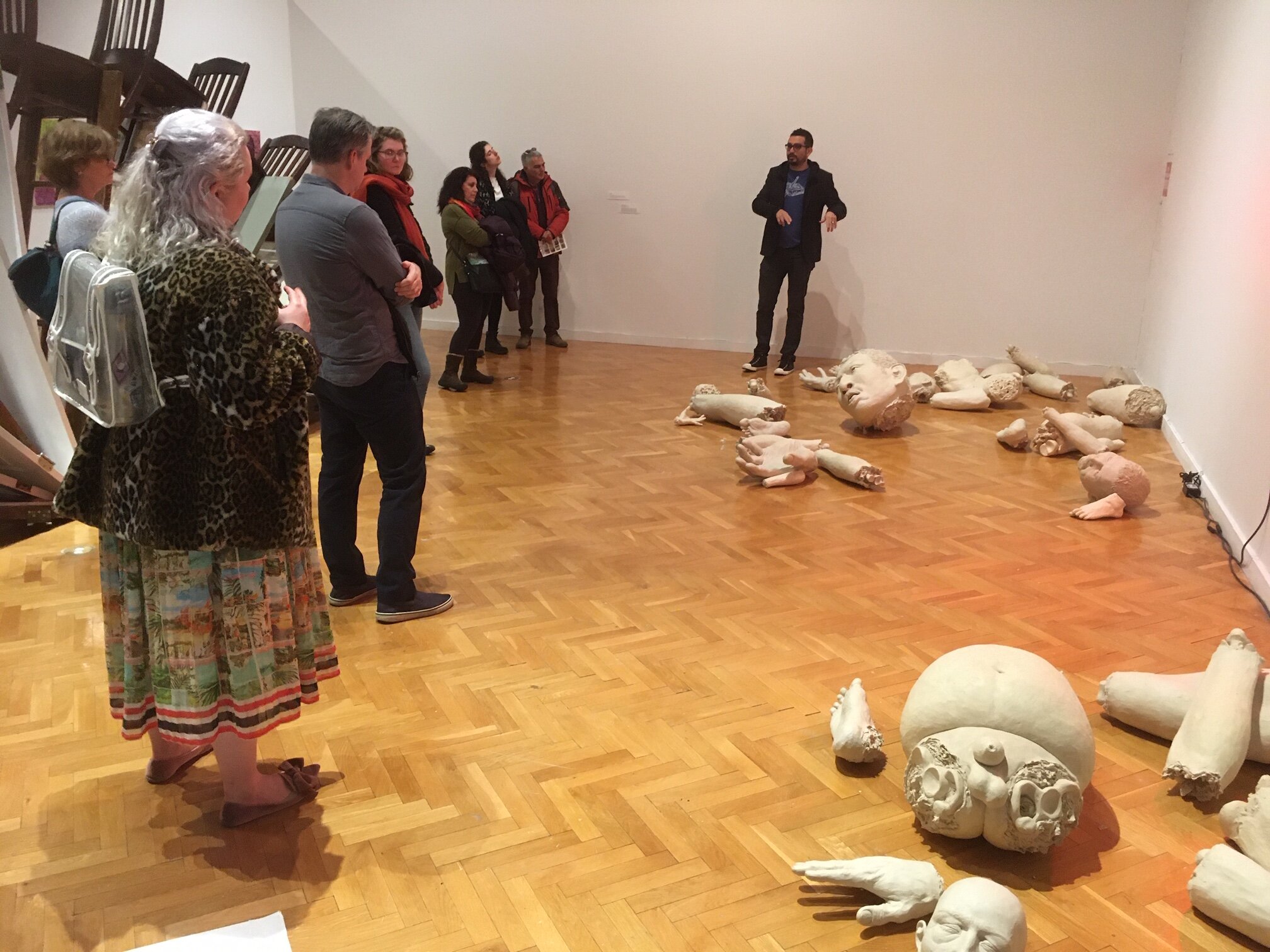  Rodrigo Lara Zendejas leading a tour of  In Flux: Chicago Artists and Immigration  at Chicago Cultural Center in early March 2020. 