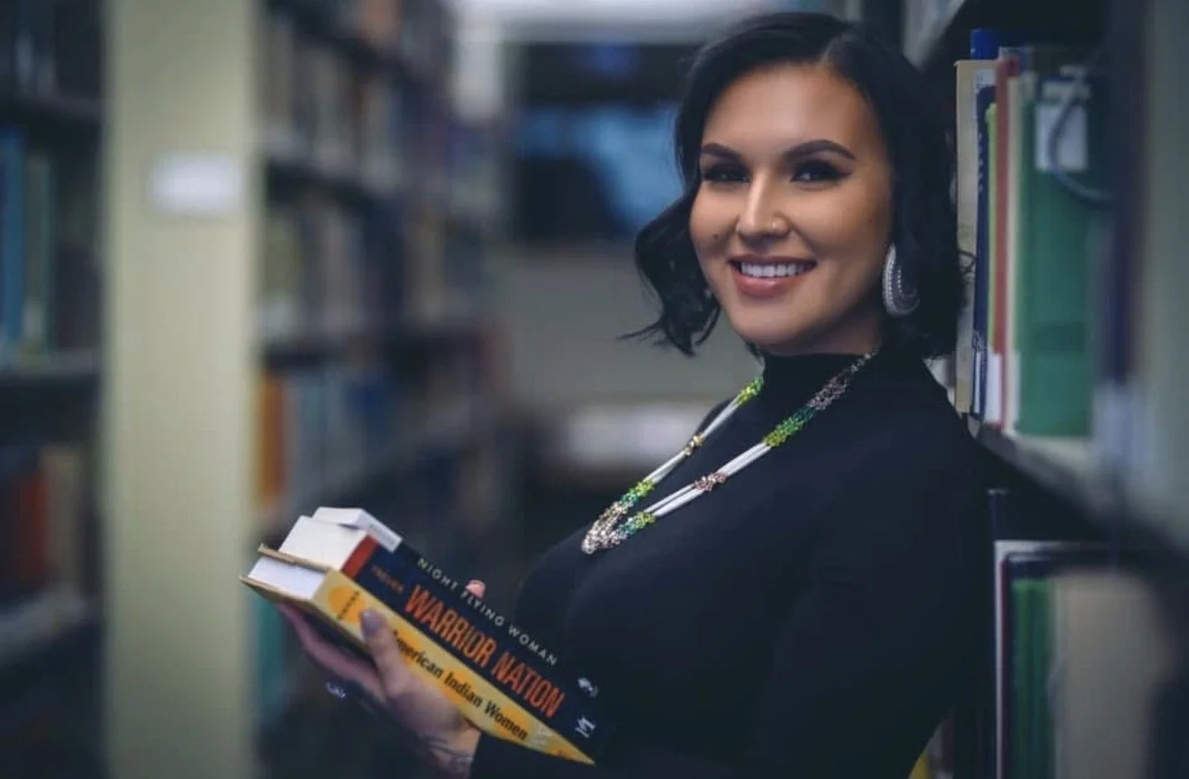 Bemidji State University alum and Red Lake tribal member Katie Northbird with her copy of Warrior Nation