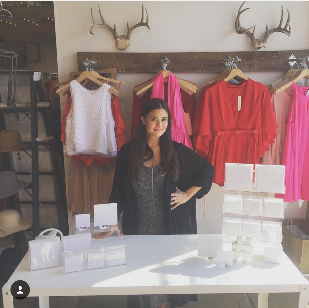 Catherine Lowe with her LoweCo. card display at Milk & Honey Boutique for a Valentine's Day event.