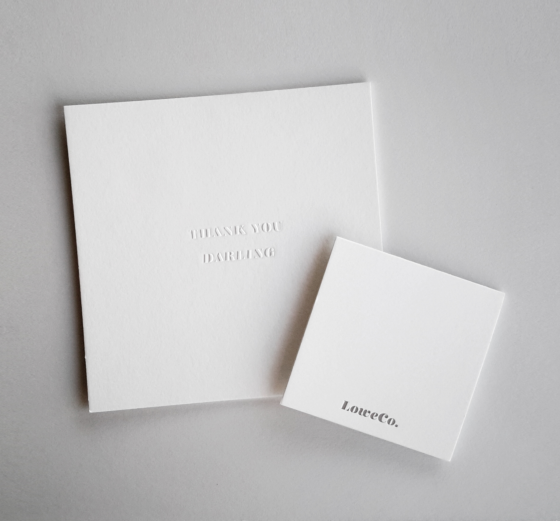 The front of our blind-embossed macho DARLING card and the back of our silver-foiled poco DARLING card.