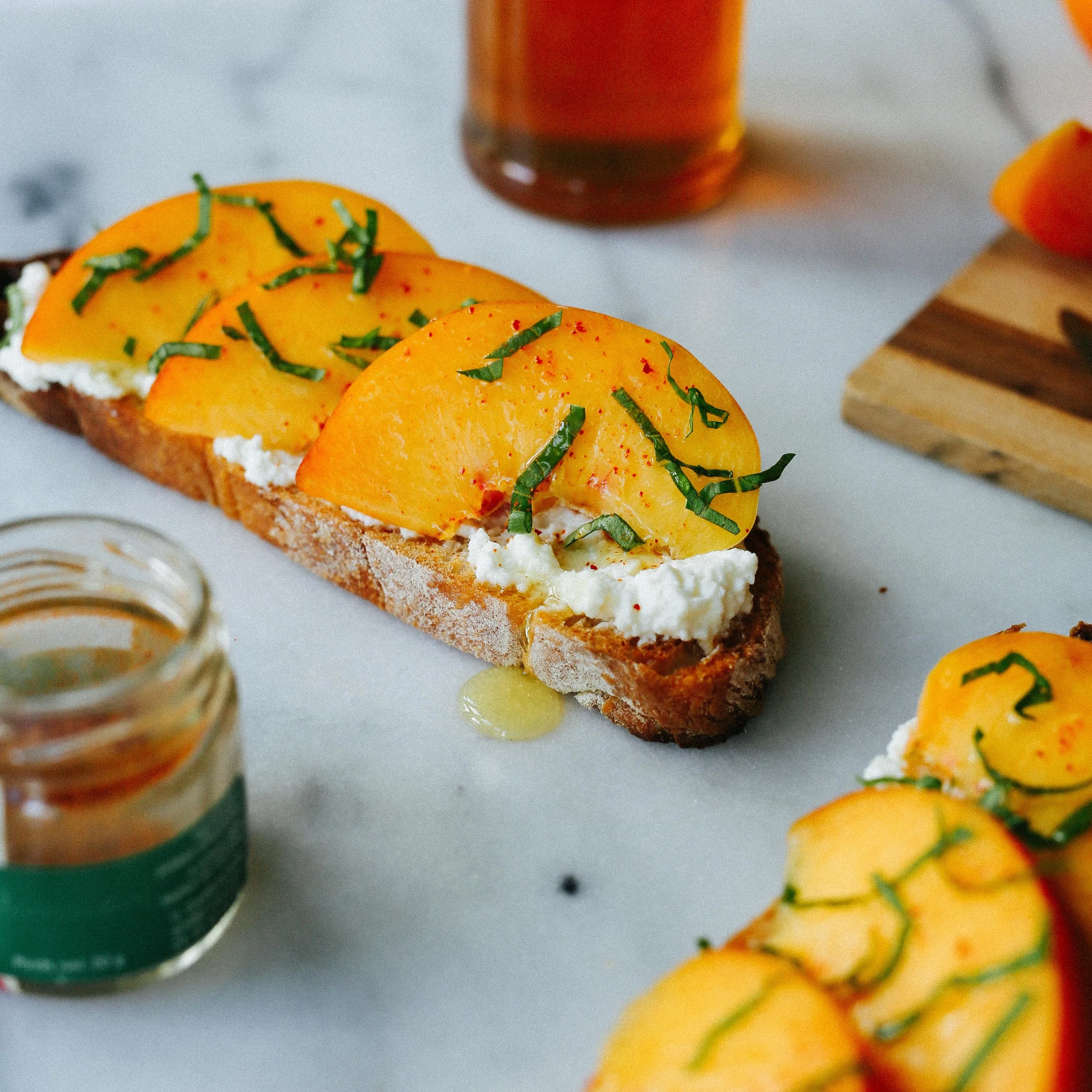 ricotta, peach, basil, and piment d'espelette tartine