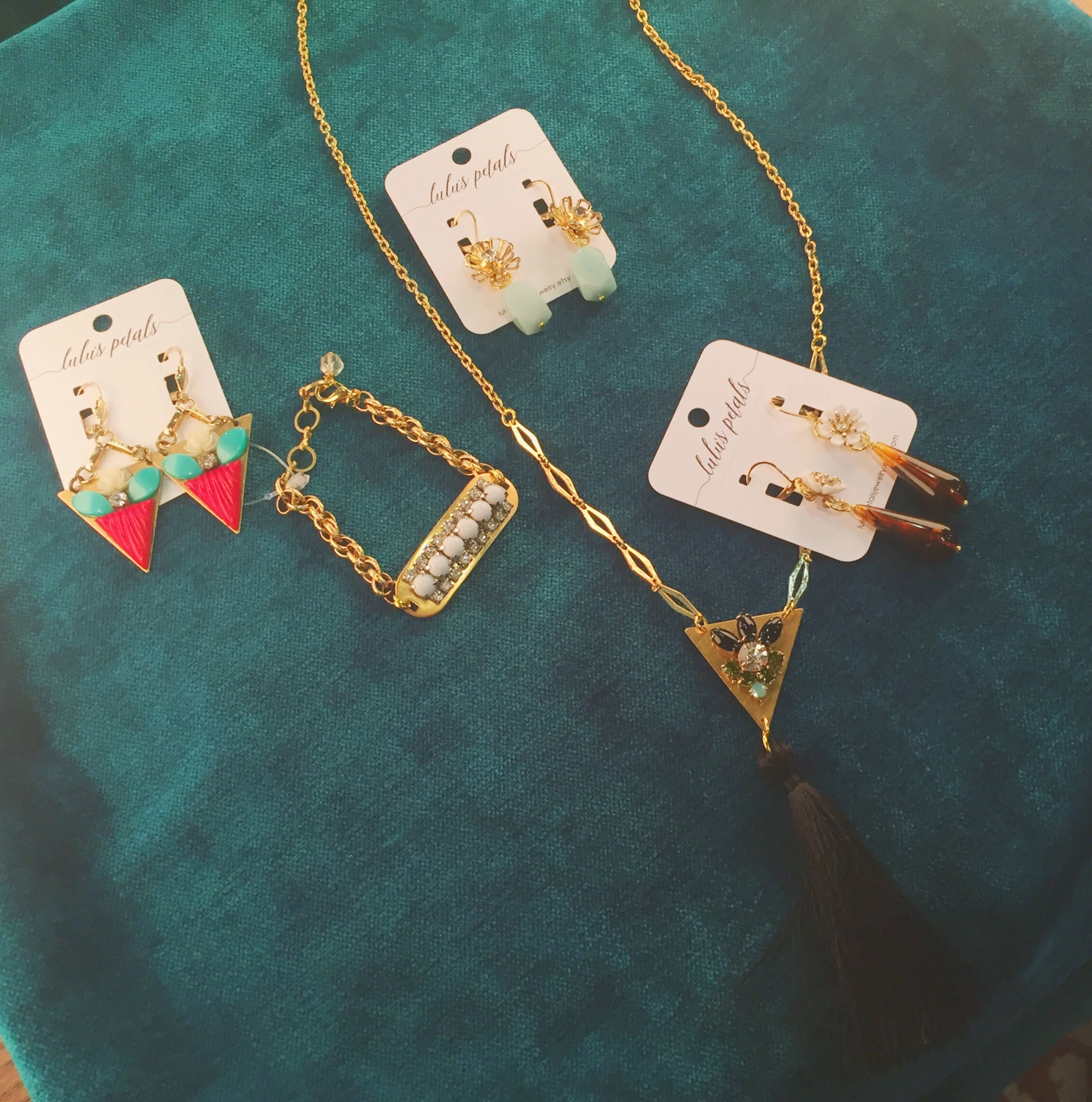 Earrings (from left to right): $42, $32, and $36; bracelet, $42; tassel necklace, $44