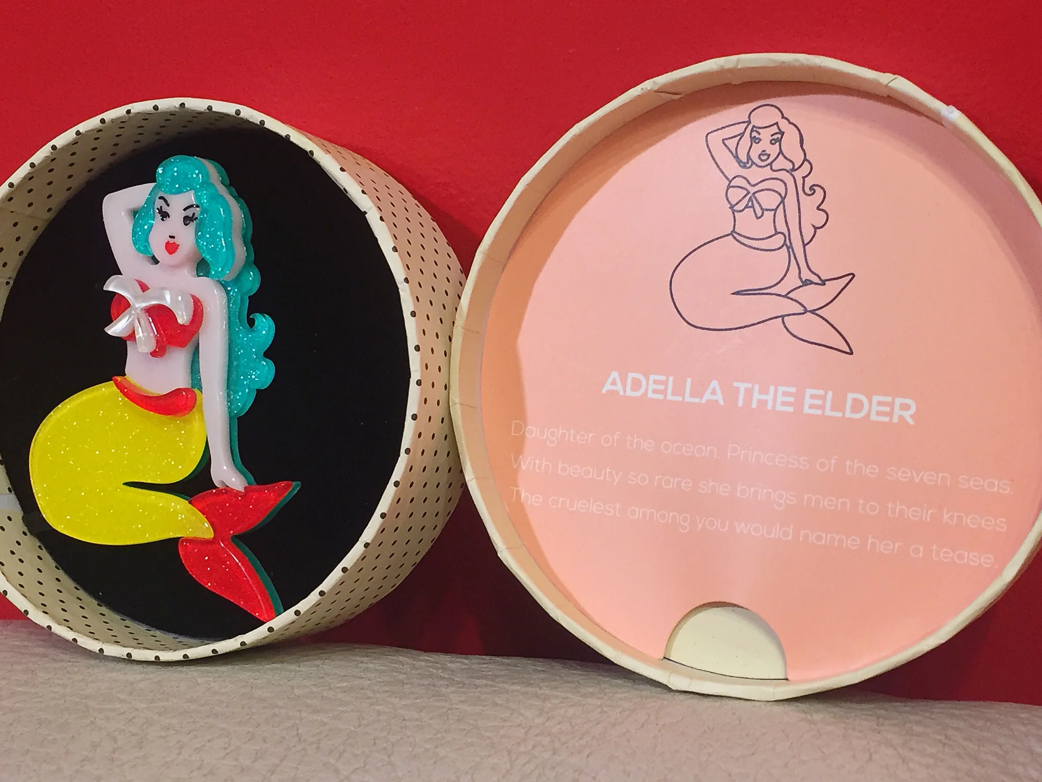 All Erstwilder pieces come with a backstory. This one reads: "Adella The Elder: Daughter of the ocean. Princess of the seven seas. With beauty so rare she brings men to their knees. The cruelest among you would name her a tease." Adella the Elder pin, $38