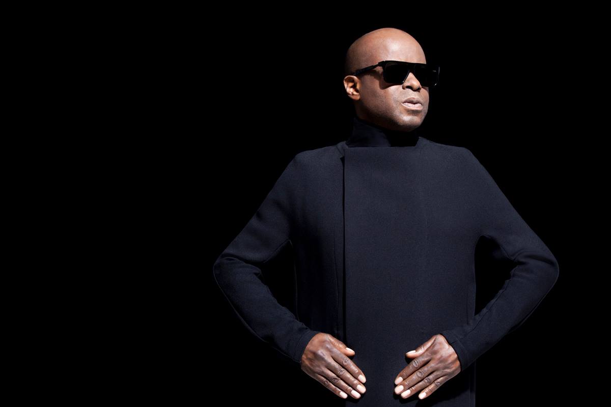 JUAN ATKINS aka Model 500 aka Cybertron At the dawn of the 1980s, Juan Atkins began recording what stands as perhaps the most influential body of work in the field of techno. Exploring his vision of a futuristic music which welded the more cosmic side of Parliament funk with rigid computer synth pop embodied by Kraftwerk and the techno-futurist possibilities described by sociologist Alvin Toffler (author of The Third Wave and Future Shock), Atkins blurred his name behind aliases such as Cybotron, Model 500, and Infiniti -- all, except for Cybotron, comprised solely of himself -- to release many classics of sublime Detroit techno. And though it's often difficult (and misleading) to pick the precise genesis for any style of music, the easiest choice for techno is an Atkins release, the 1982 electro track "Clear," recorded by Atkins and Rick Davis as Cybotron. He soon left the progressively album-oriented Cybotron to begin working alone, and released his most seminal material from 1985 to 1989 as Model 500. And while fellow Detroit legends Kevin Saunderson and Derrick May were known for their erratic output during the following decade, Atkins recorded much more during the '90s than he had during the '80s, soaking up new rhythmic elements from contemporary dance music but keeping his unerring, instantly recognizable sense of melody intact throughout. As the electronic scene began looking back to the past to find musical innovators, Atkins was a name much-discussed and -anthologized, hailed as the godfather of techno. Born in Detroit in 1962 (the son of a concert promoter), Juan Atkins began playing bass as a teenager and then moved on to keyboards and synthesizers after being turned on to their use in Parliament records. Two local DJs, Ken Collier and the Electrifyin' Mojo, first introduced Atkins to a wide range of other synthesizer-driven bands -- Kraftwerk, Telex, Gary Numan, Prince, the B-52's -- in the late '70s. Atkins then turned on two friends he had met (initially through his younger brother) while attending Belleville Junior High School, Derrick May and Kevin Saunderson. He also bought his first synthesizer, a Korg MS10, and began recording with cassette decks and a mixer for overdubs. Hoping to learn more about the burgeoning field of musical electronics after high school graduation, Atkins studied at Washtenaw County Community College in nearby Ypsilanti; there he met Rick Davis, a Vietnam War veteran, synthesizer expert and fellow Electrifyin' Mojo devotee -- Davis had even released an experimental record used by Mojo to open his radio show. The two began recording as Cybotron and released their first single, "Alleys of Your Mind," in 1981 on their own Deep Space Records. The clever balance of urban groove and synthesizer futurism signaled the new electro wave in black music; though crossover success for electro was quite limited, it went on to become one of the most influential styles for the new electronic music of the next decade. "Alleys of Your Mind" got immediate play from Electrifyin' Mojo and became a big local hit, even though most listeners had no idea it was recorded in Detroit, or America for that matter. The 1982 single "Cosmic Cars" also did well, and Cybotron recorded their debut album, Enter. Then the group signed a deal with Fantasy Records to reissue the album. One track, "Clear," was a quasi-instrumental which set the blueprint for what would later be called techno. Instead of merely reworking elements of Kraftwerk into a hip-hop context (which proved the basis for many electro tracks), "Clear" was a balanced fusion of techno-pop and club music. Unfortunately, competing visions for the future of the group forced him to leave the group by 1983. Davis and new member Jon 5 argued to pursue a musical direction closer to rock & roll, while Atkins wanted to continue in the vein of "Clear." (Cybotron carried on in the direction proposed by Davis, and was promptly forgotten.) Juan Atkins had no trouble staying busy during the mid-'80s. He continued working with the music collective Deep Space Soundworks which he, May, and Saunderson had founded in 1981 to provide a club-based forum for their music. Later, the Deep Space family founded their own club, the Music Institute, in the heart of downtown Detroit. It soon became the hub of the Motor City's growing underground family, a place where May, Atkins, and Saunderson DJed along with fellow pioneers like Eddie "Flashin" Fowlkes and Blake Baxter. The club invigorated the fractured sense of community in Detroit, and inspired second-wave technocrats like Carl Craig, Stacey Pullen, Kenny Larkin, and Richie Hawtin (Plastikman). Of course, Atkins continued recording during this time, and the period from 1985 to 1987 proved to be his most influential period. He founded his own label, Metroplex Records, in 1985 and recorded his first single as Model 500, "No UFO's." Derrick May, who was living in Chicago at the time, invited Atkins over and told him to bring his records. The duo sold thousands of copies, and "No UFO's" soon became a hit with Chicago mix shows like the Hot Mix 5. Later Metroplex singles like "Night Drive," "Interference," and "The Chase" also sold well and set the template for Detroit techno; moody and sublime machine music, inspired by the drone of automated factories and trips down the I-96 freeway late at night. By 1988, Britain had caught up with the advanced music coming from Chicago and Detroit; soon Atkins, May, and Saunderson made their first trip (of hundreds) across the Atlantic, in Atkins' case before thousands of people at one of the open-air raves typical of England's Summer of Love. Acts like 808 State, A Guy Called Gerald, LFO, and Black Dog began due in large part to the influence of Atkins, and the man himself was invited to remix current pop acts like Fine Young Cannibals, Seal, Tom Tom Club, the Beloved, and the Style Council. Though dance music in Great Britain shifted its course radically from 1989 to 1991 (to the burgeoning, cartoonish sounds of rave and hardcore), others in Europe were quick to take up the cause of championing Detroit's techno elite. First, the Belgian R&S Records began releasing stellar work by a cast of techno inheritors including New Yorker Joey Beltram and Europeans C.J. Bolland and Speedy J. By 1993, Berlin's Tresor Records had picked up the baton as well, issuing American projects by second-wave Detroit producers Underground Resistance (as X-101), Jeff Mills, Blake Baxter, and Eddie Fowlkes. Atkins visited the label's studio in 1993 and worked with 3MB, the in-house production team of Thomas Fehlmann and Moritz Von Oswald (both of whom were to go on to better things, in Sun Electric and Basic Channel/Maurizio, respectively). He returned to Berlin several years later to begin recording what was, surprisingly, his first album since the days of Cybotron. Finally, in mid-1995, R&S released the debut Model 500 album, Deep Space; more importantly, the label also released Classics, a crucial compilation of Model 500's best Metroplex singles output. Another retrospective, Tresor's Infiniti Collection, traced Atkins' work as Infiniti, recorded from 1991 to 1994 for a variety of labels including Metroplex and Chicago's Radikal Fear. Several years passed before he released any additional material, but it came with a rush during 1998-1999. First in September 1998, Tresor released an album of new Infiniti recordings named Skynet. One month later, the American label Wax Trax! released a Juan Atkins mix album. The second full Model 500 album, Mind and Body, was released in 1999 on R&S. Atkins remained active throughout the early 2000s. He put together Classics (2002), a mixed compilation of Metroplex highlights. An album of new productions, The Berlin Sessions, came out through Tresor, and so did the double-disc 20 Years Metroplex. Both of them were released in 2005.