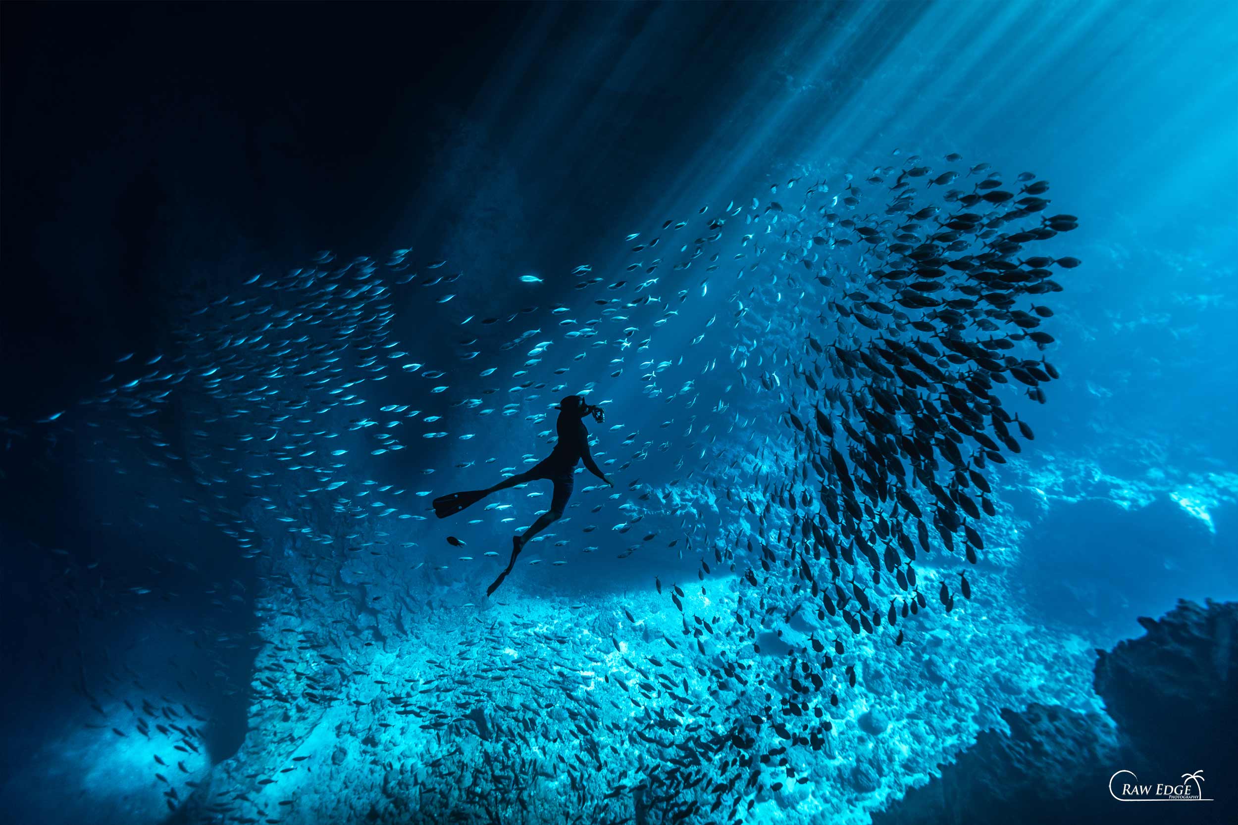 Underwater Photographer Kian Bates swimming in cave Tonga