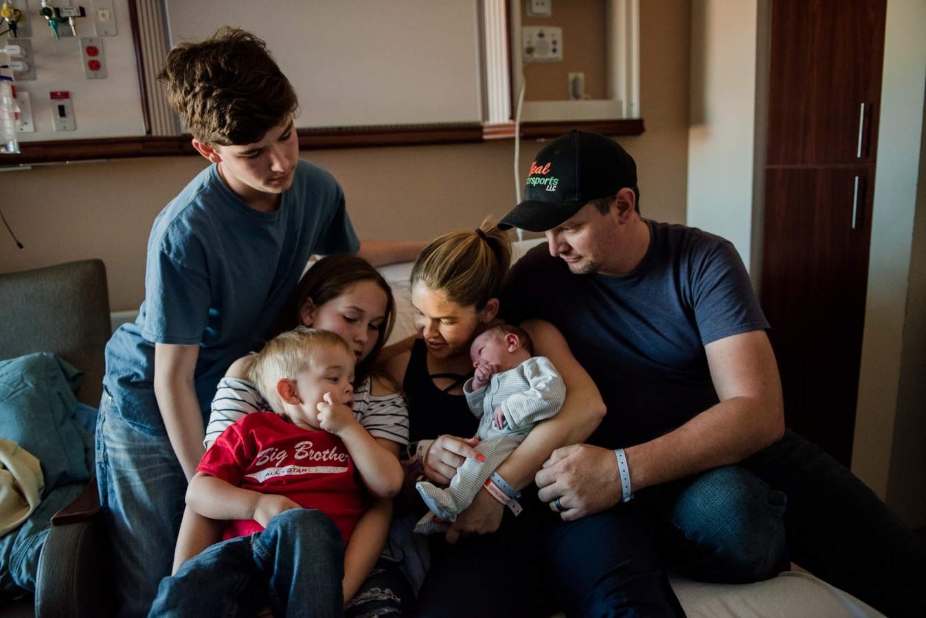 family gathered around baby- pensacola family photographer