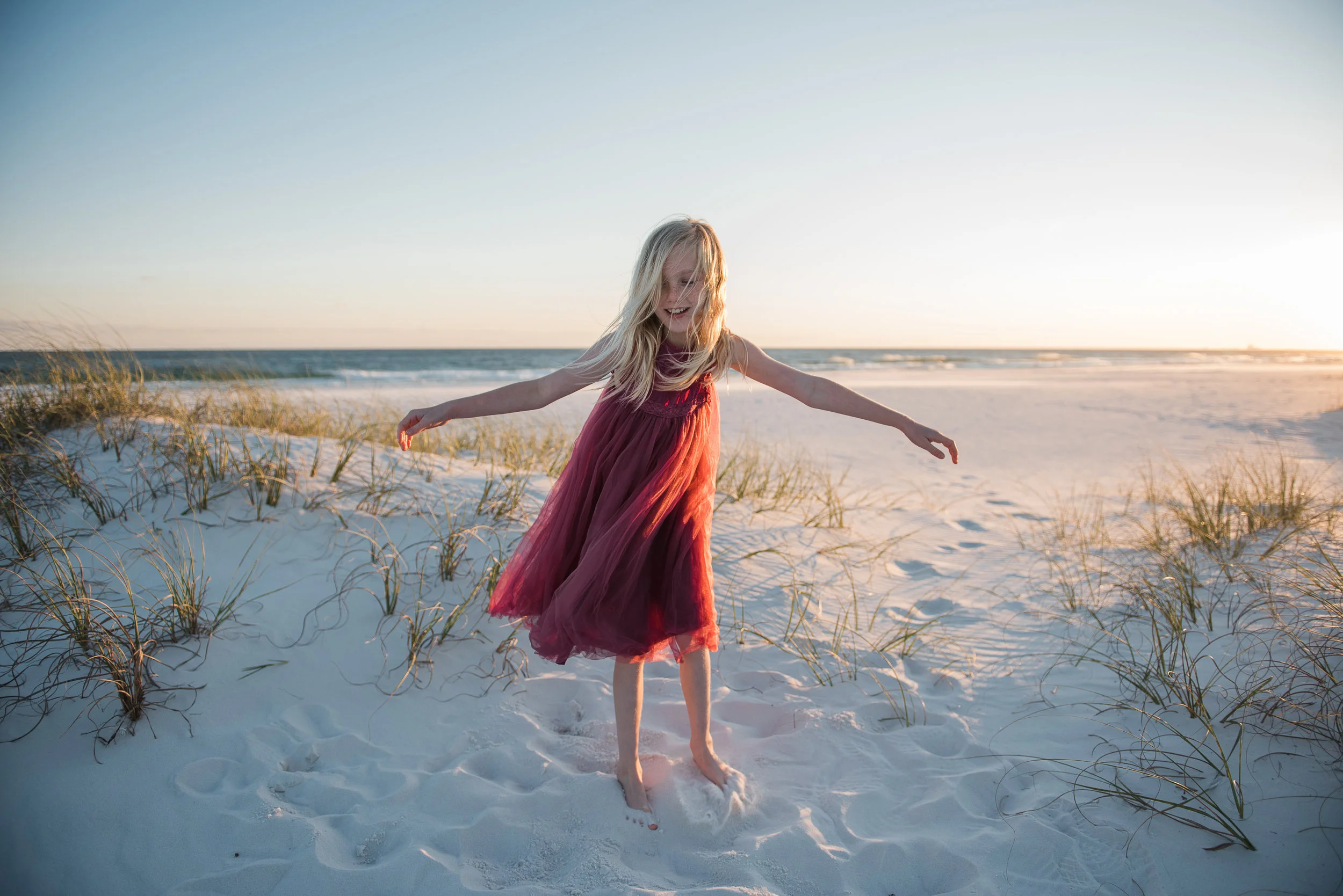 girl twirling in red dress-child photographer-Pensacola