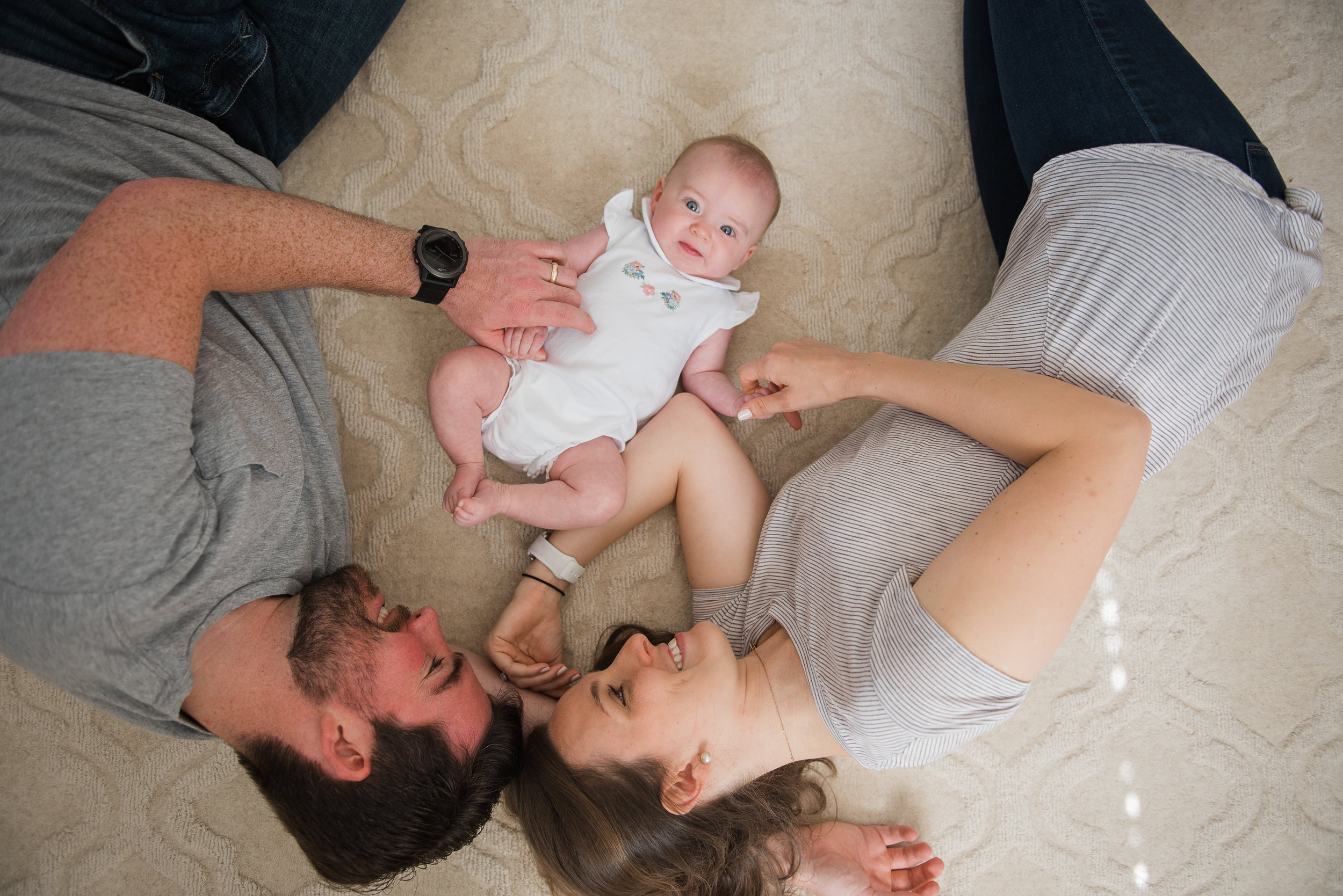 mom and dad in floor with baby