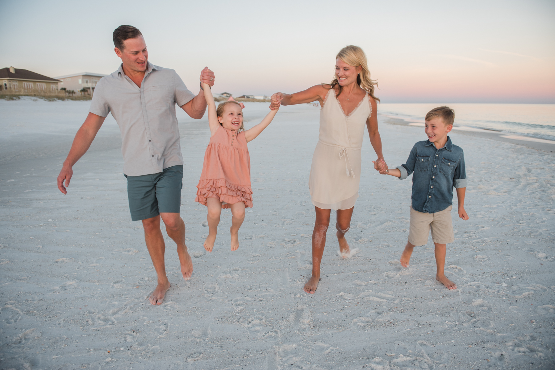 family walking on beach- Pensacola Beach family photographer