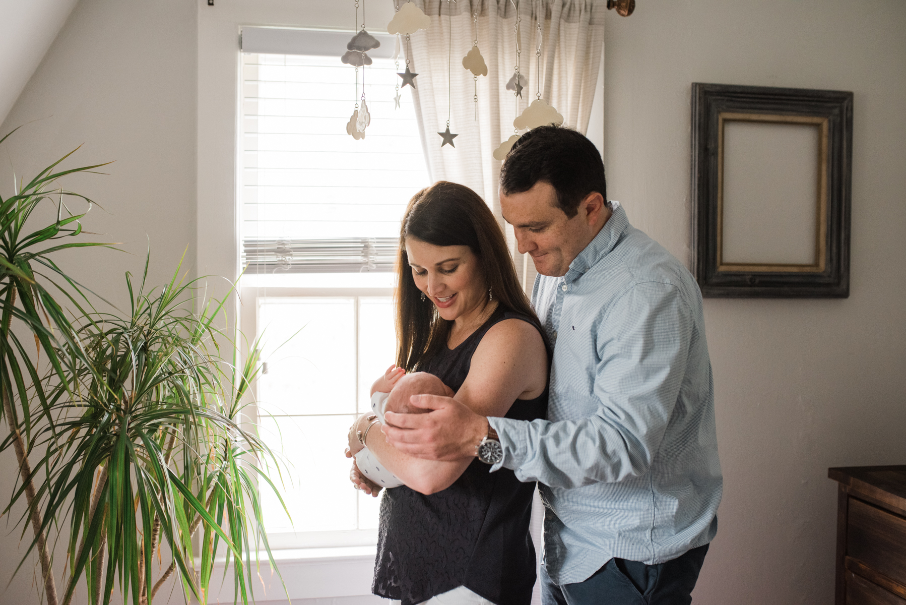 mom and dad with dad hands on baby- pensacola newborn photographer- ann mangum photography