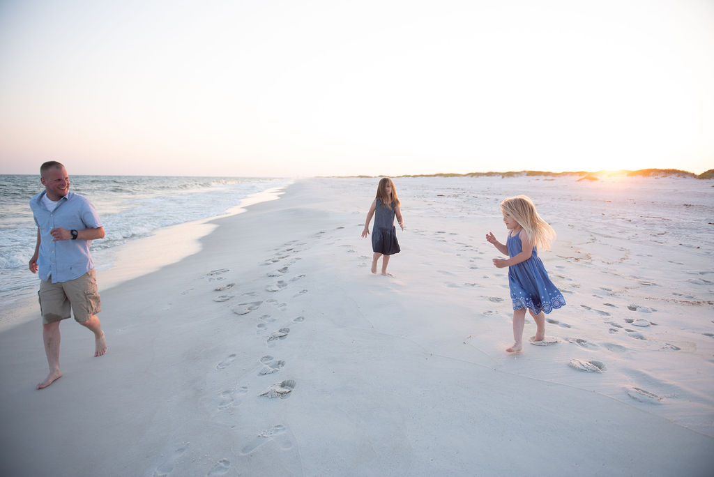 dad running with girls on beach- Navarre Beach photographer