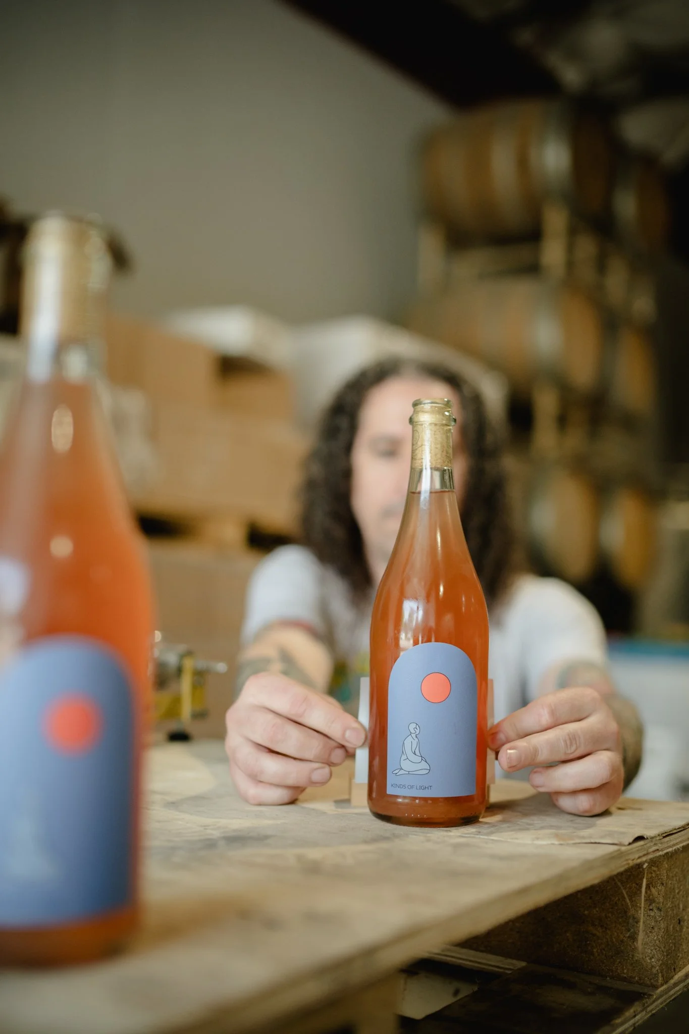 Josh hand labeling wine bottles with the precision of a machine.