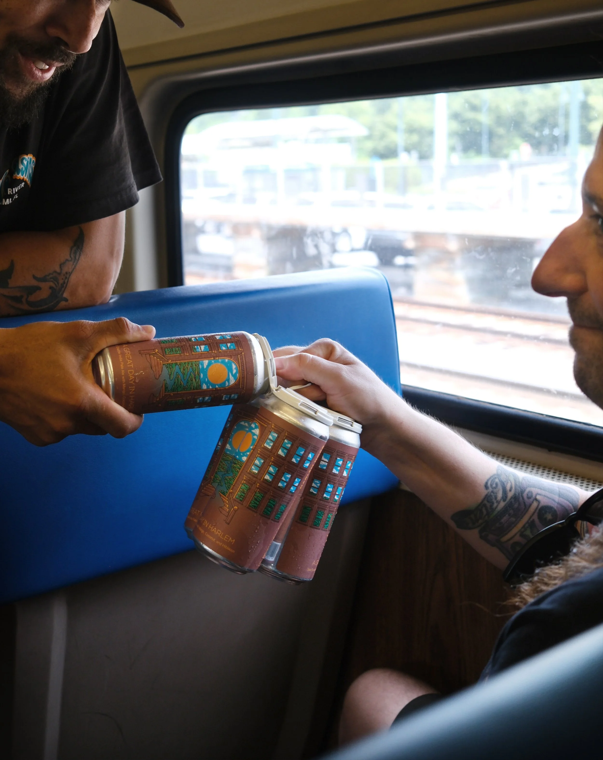 Jamal grabbing a beer from Josh's four-pack.
