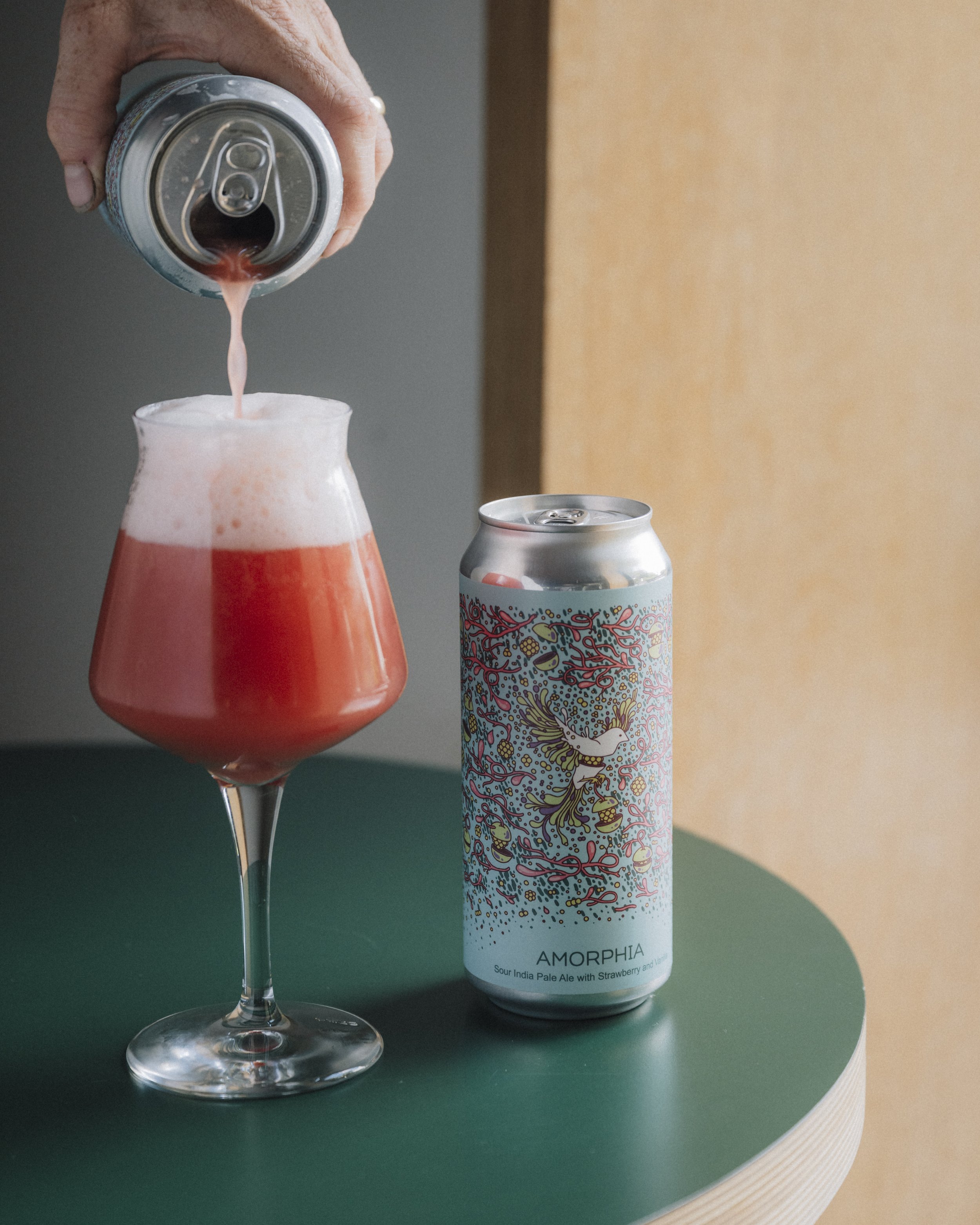 Amorphia in a can and being poured into a glass