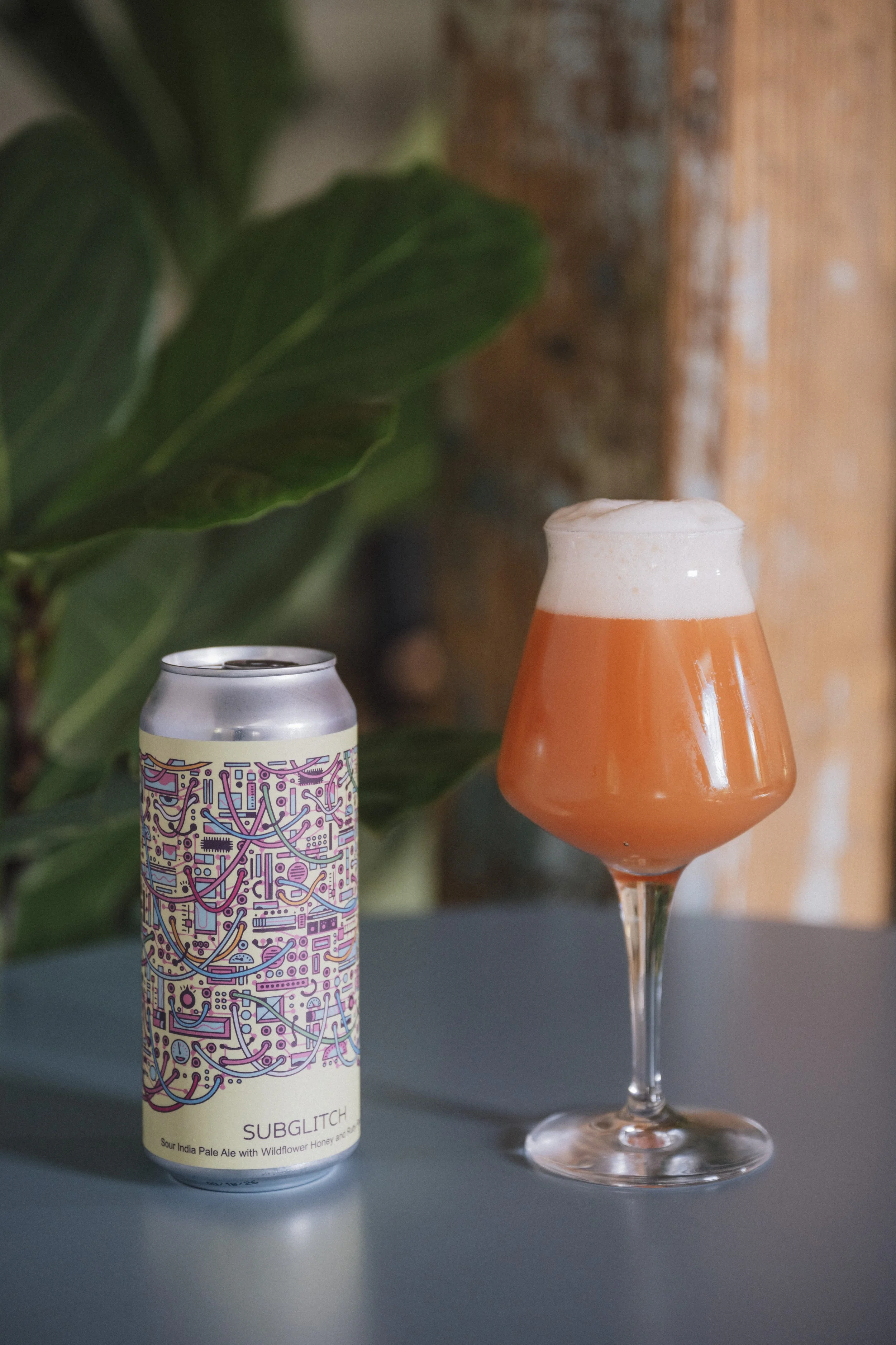 Subglitch Sour IPA in glass and can.