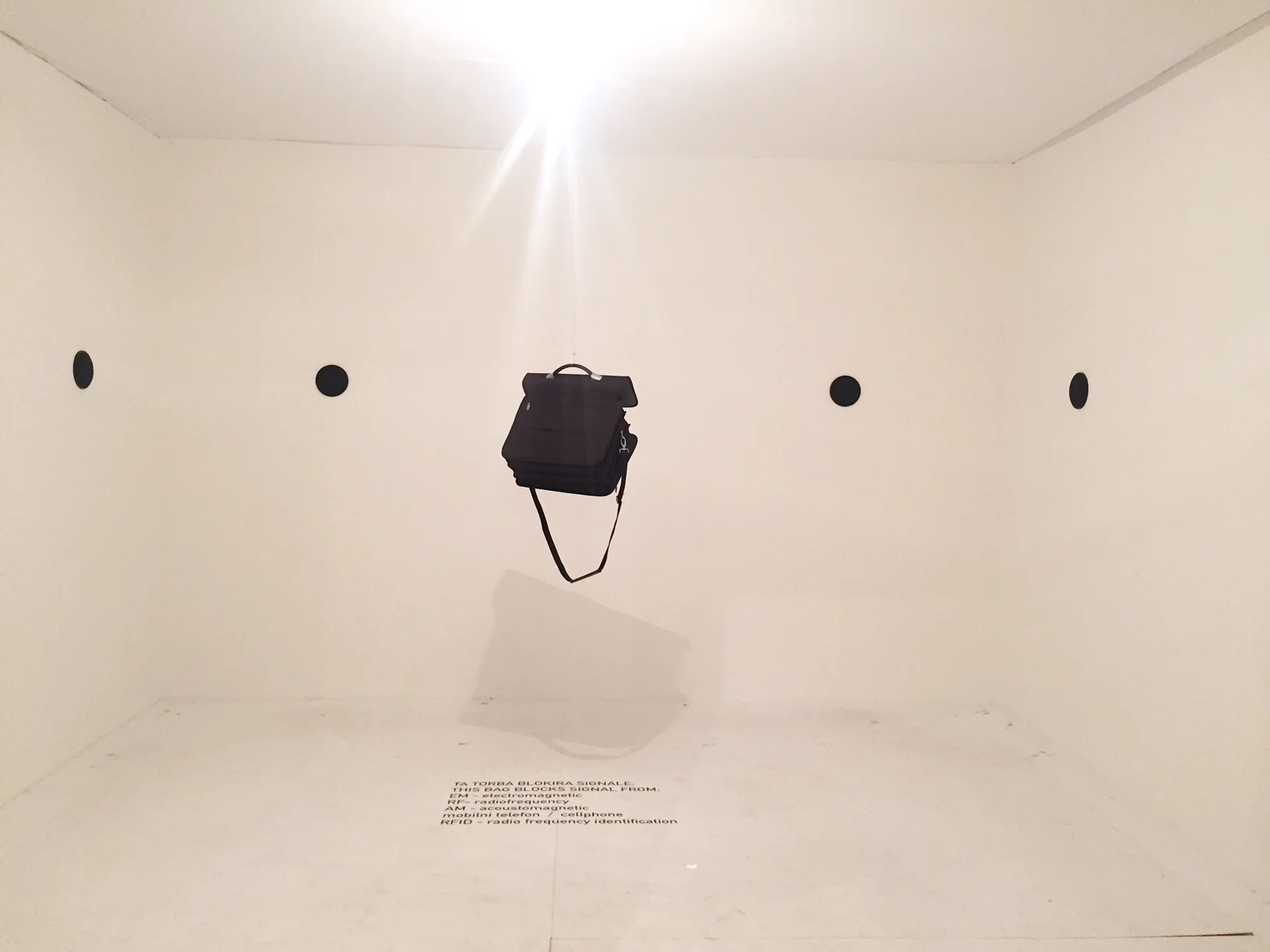 Why is there a messenger bag hanging up in a room? What does it mean?
