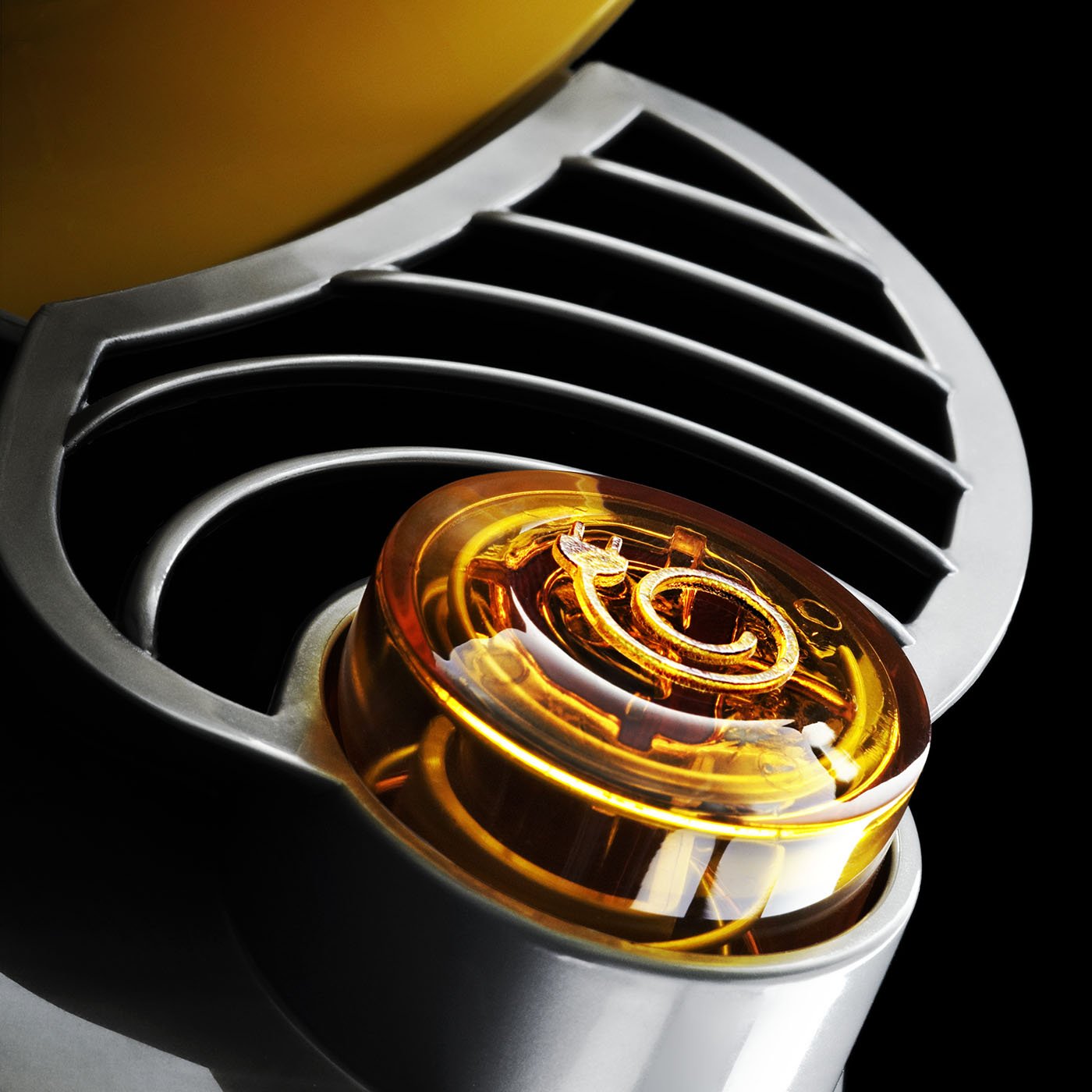  A Detailed close up photograph of a Dyson Vacuum cleaner photographed on a black back ground creating an abstract shape. 