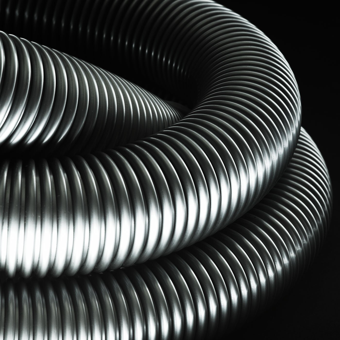  A Detailed close up photograph of a Dyson Vacuum cleaner photographed on a black back ground creating an abstract shape. 