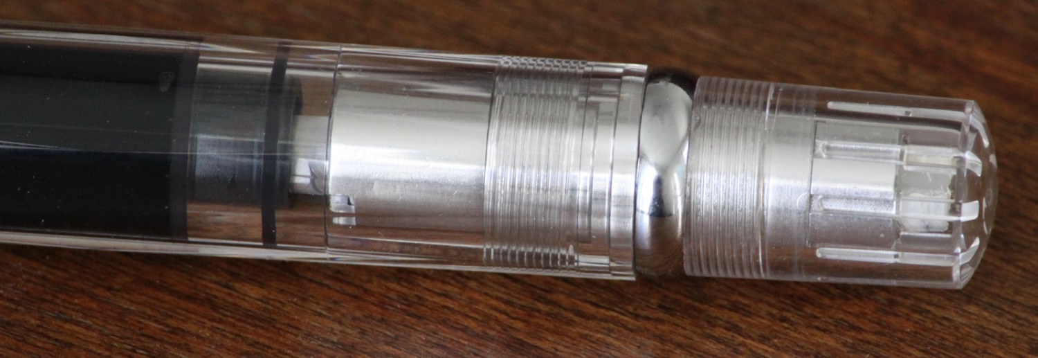 Twist this piston mechanism to draw in or push out ink. Think of this pen as a giant converter.