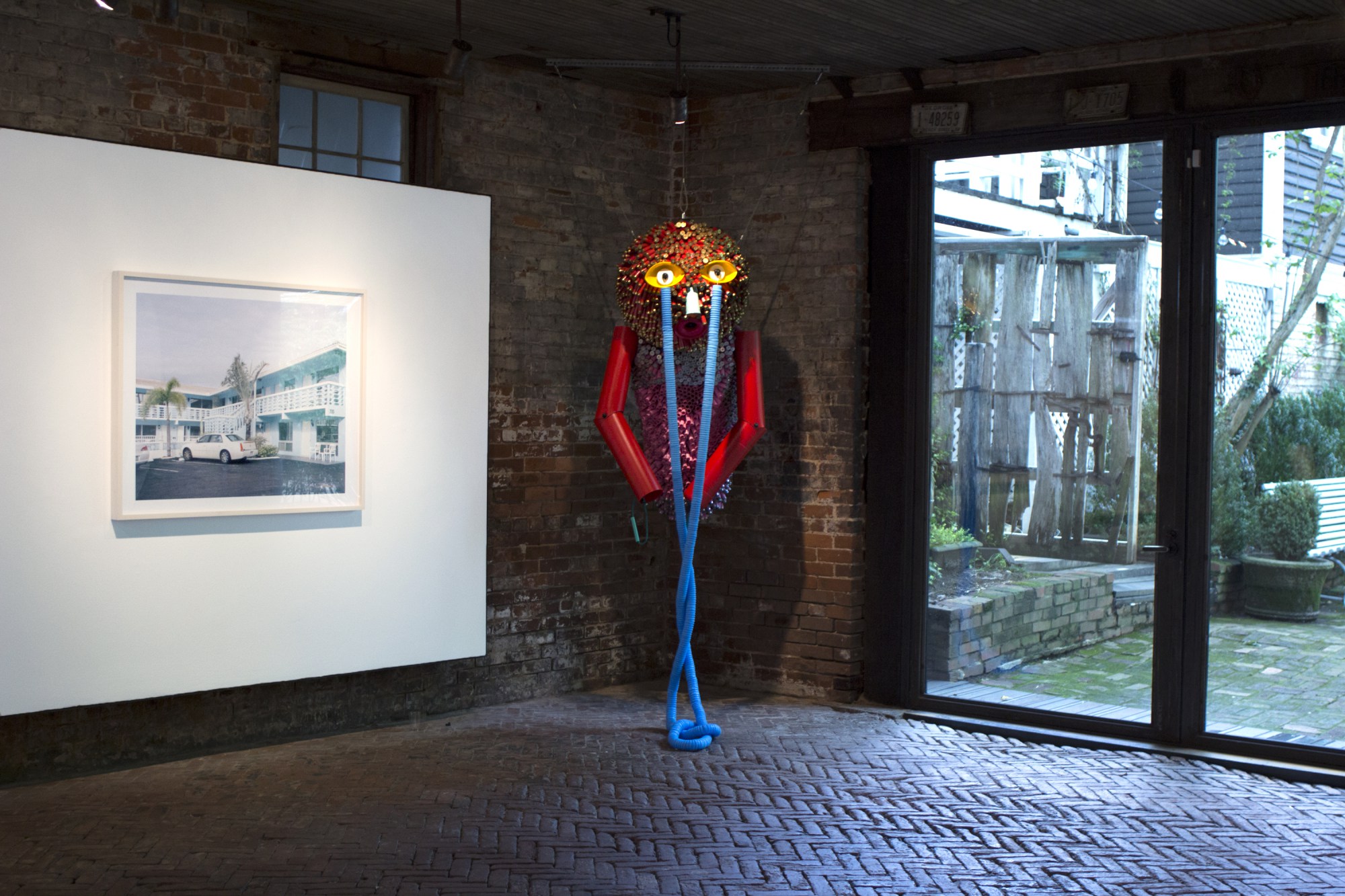 Installation view of “Luminous Animals” at Whitespace with (l to r) photo by Caroline Allison and hanging sculpture by Alex Lockwood.