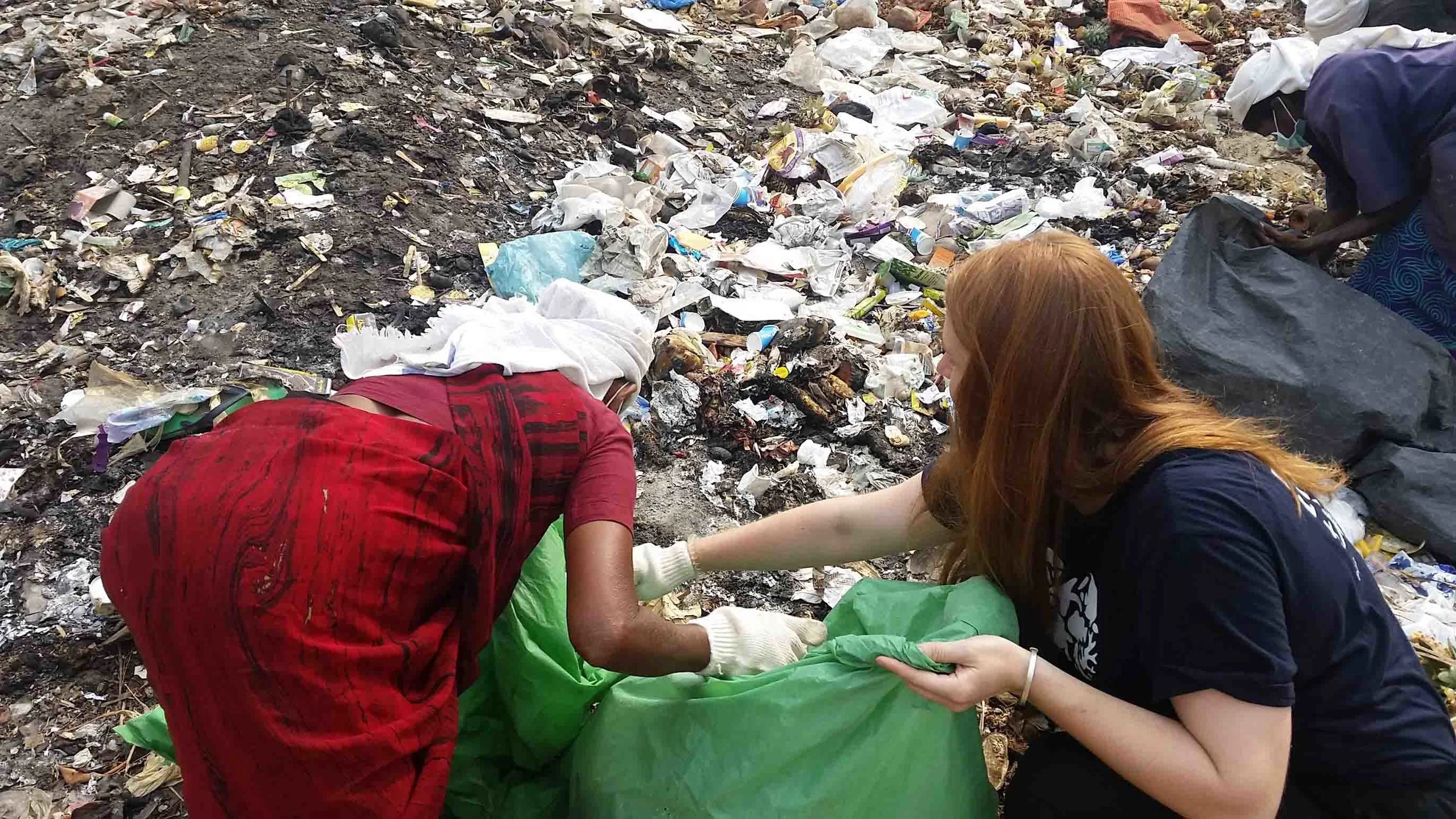 Kasey, one of our waste management team members, assisting the local women from Eco Preserve with their recycling and collection work.