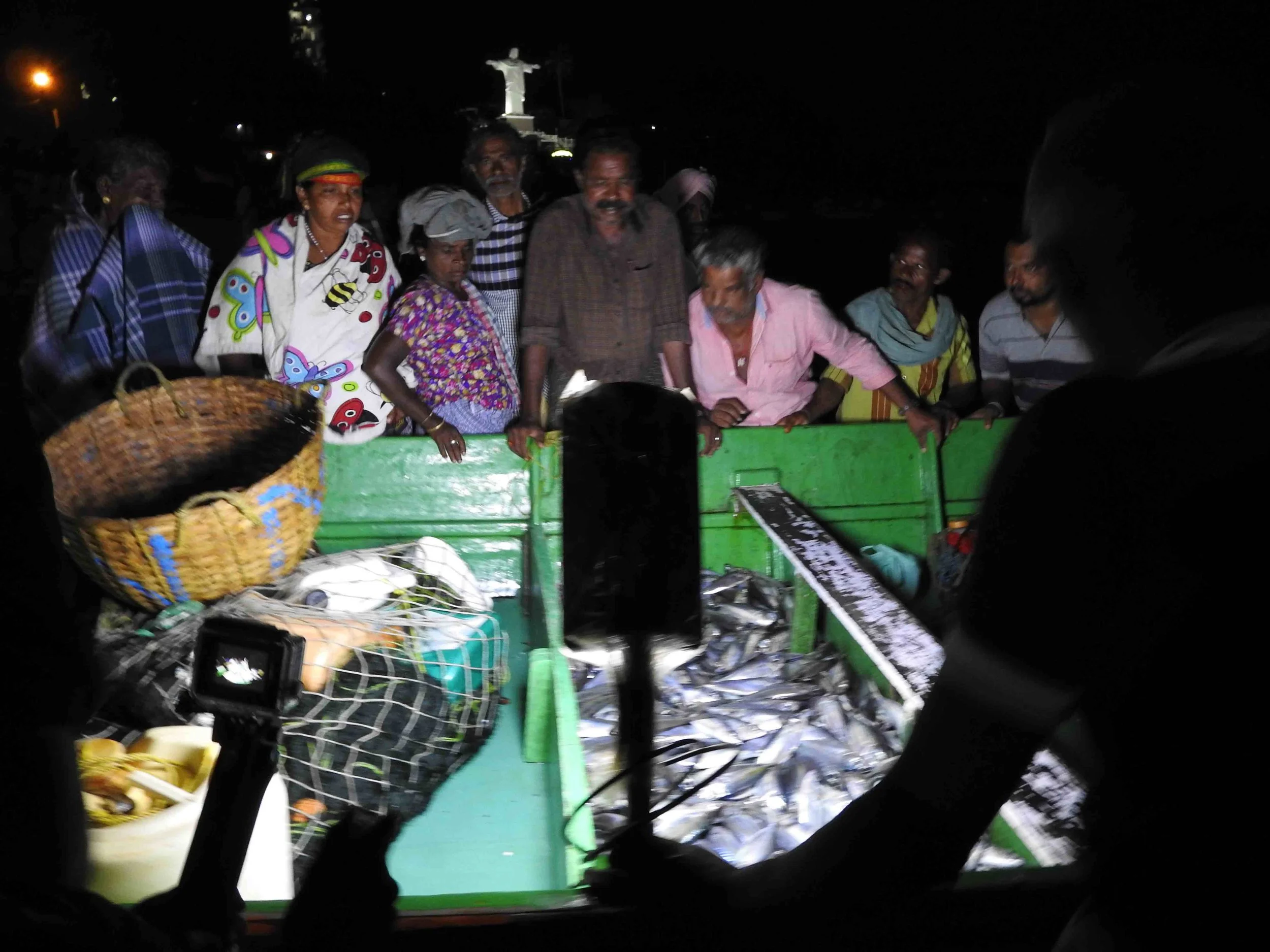Local buyers and traders survey the haul from the night-long catch in the early hours before dawn.