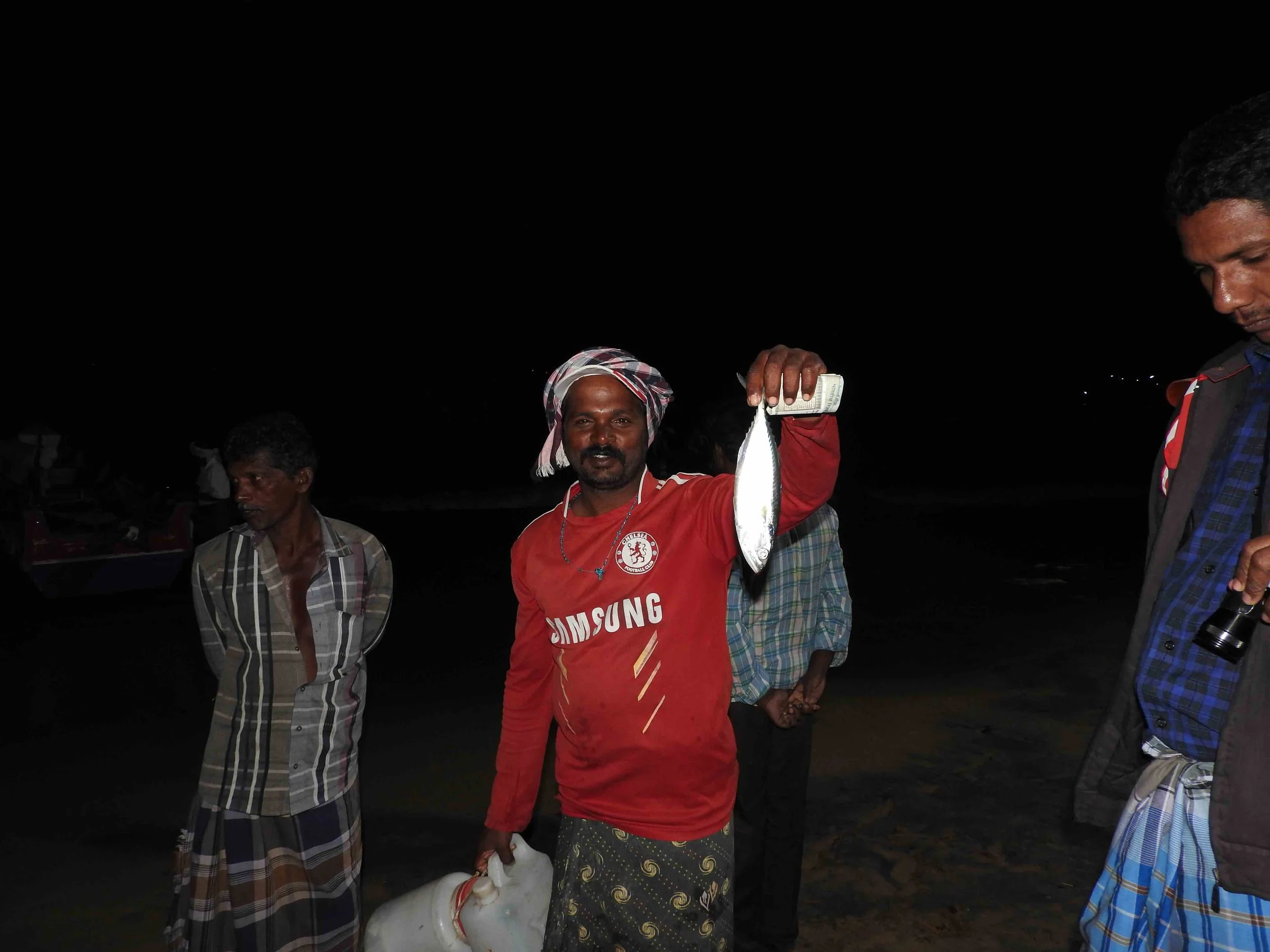 A local fishermen offering our team a fish from his catch. Large fish are a rare occurrence in the coastal villages in this region.