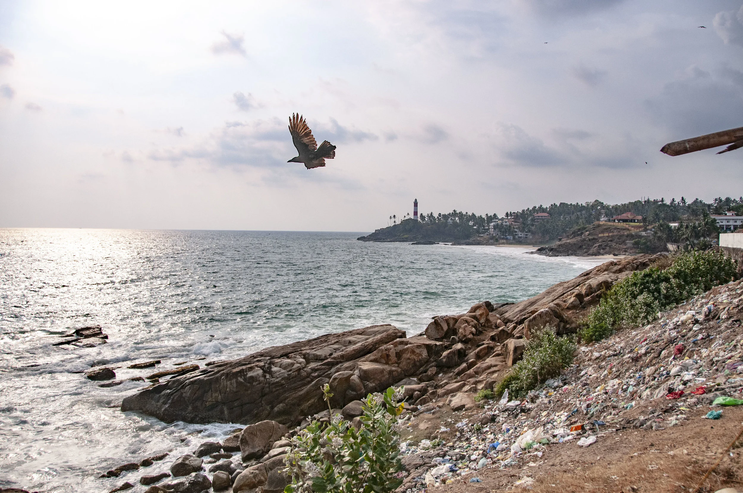 A makeshift dump site on the cliffs of Vizhinjam. Dumps like these are common throughout the communities in which we work.