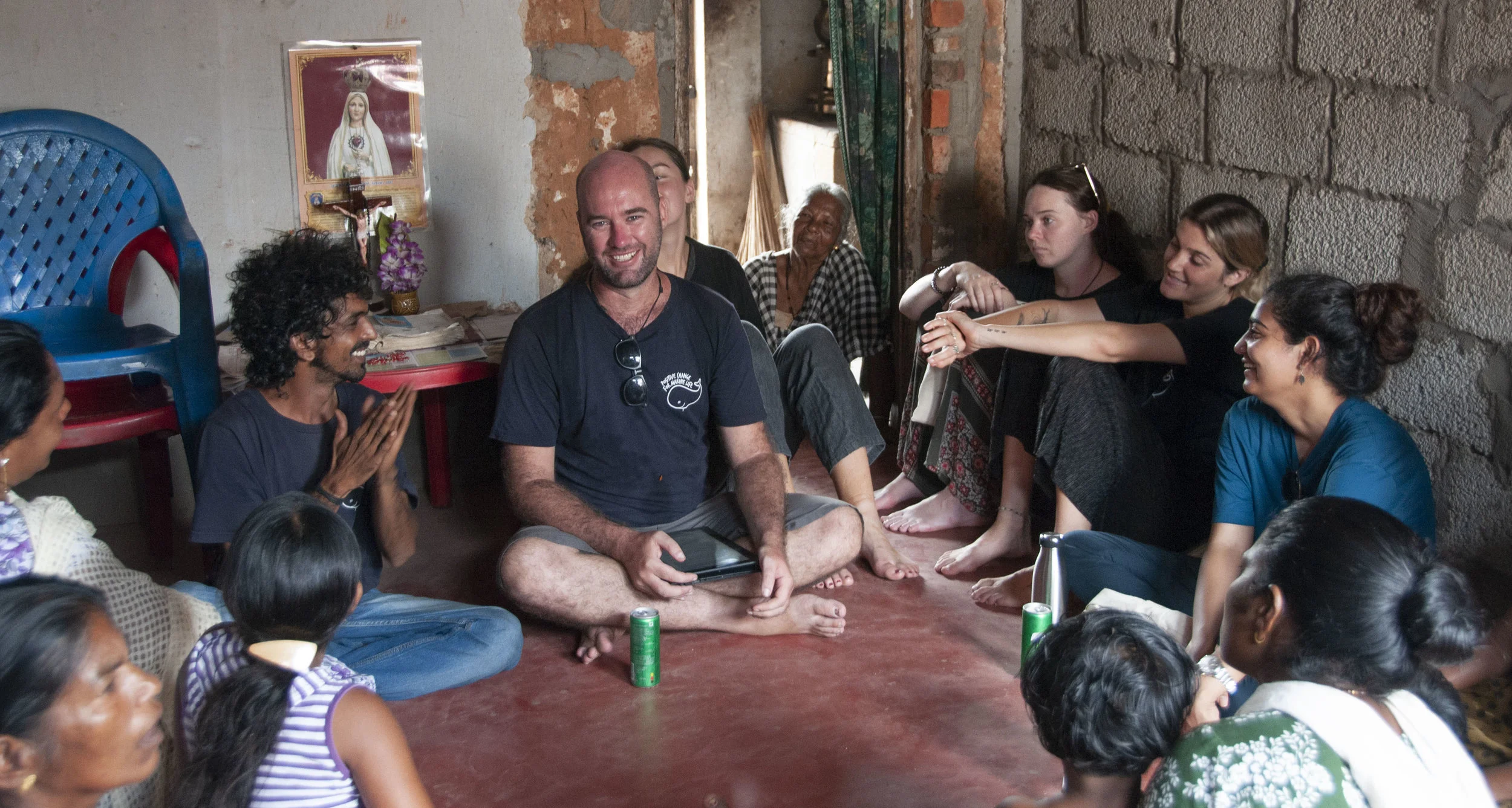 Our two Coordinators Blake and Krishna, alongside our team of Ambassadors chatting to a group of local women from Vizhinjam.