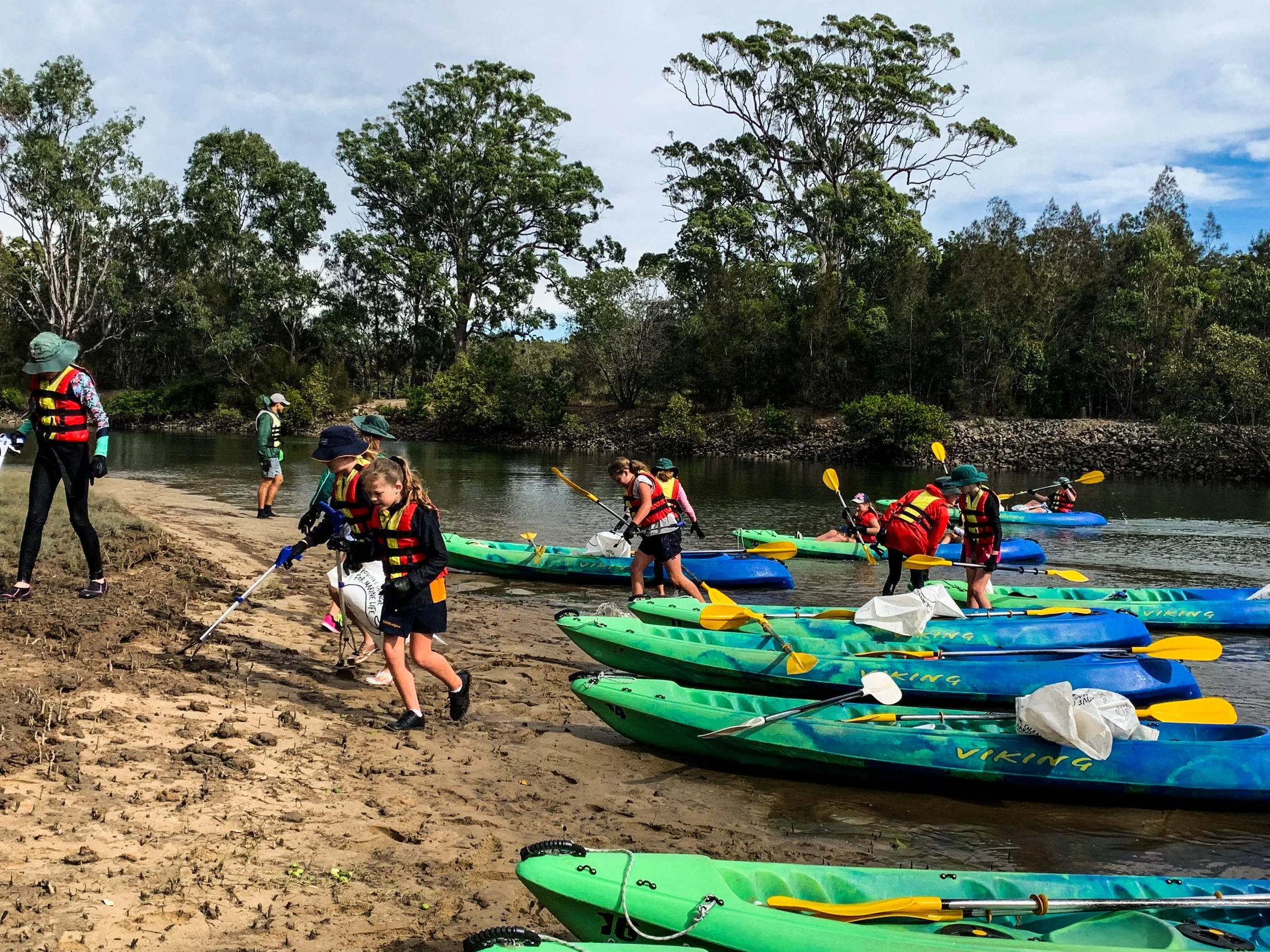 Stopping along the river banks to collect debris.