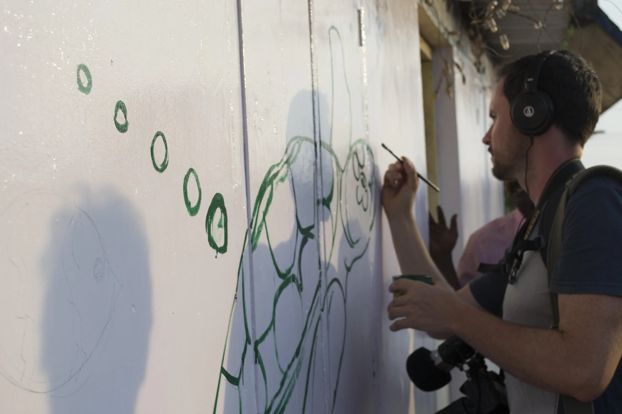 Painting some of the first strokes of our marine mural in the coastal village of Vizhinjam, southern India.