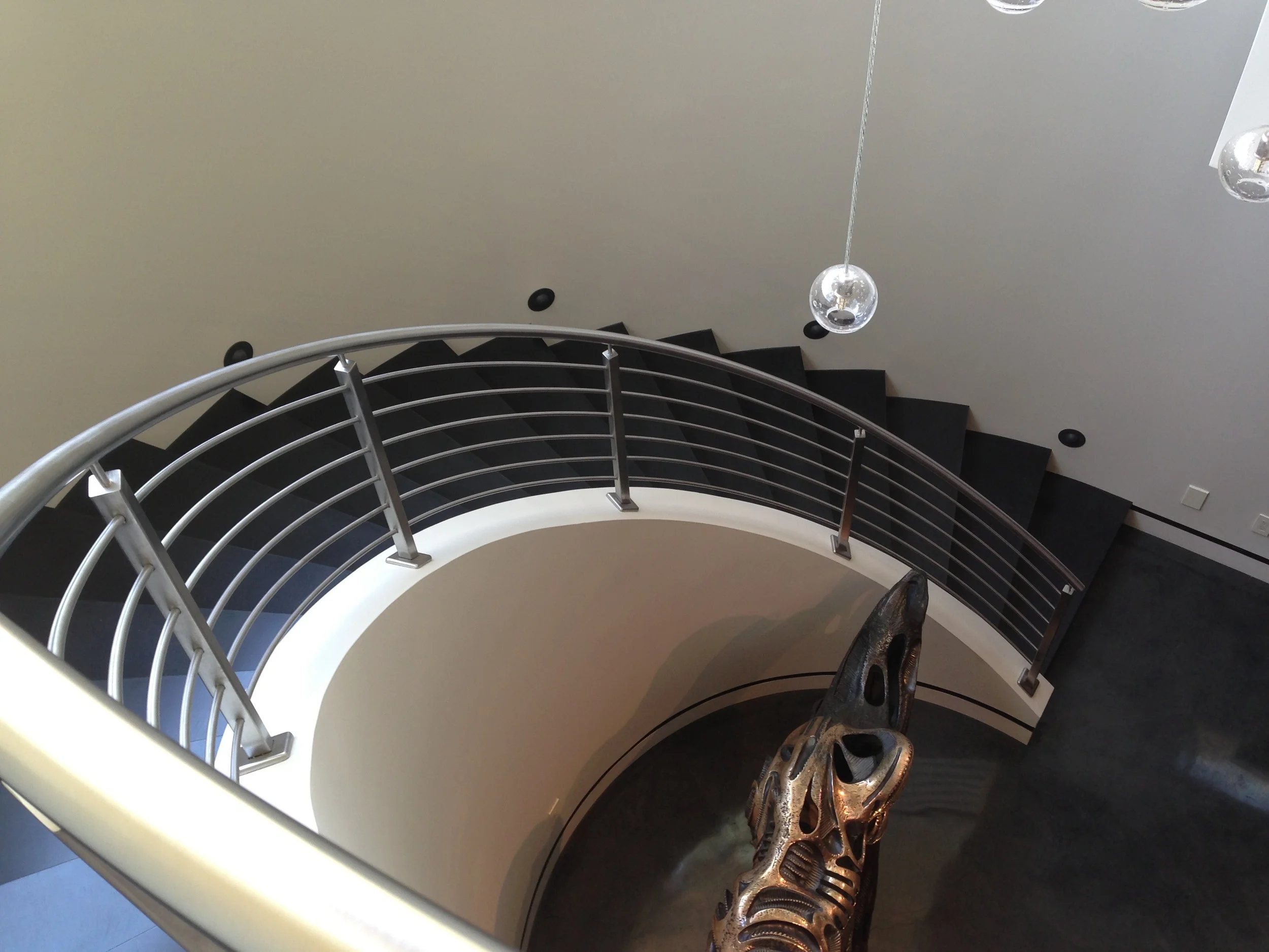 concrete stairs, custom, black stairs, spiral stair case, metal hand rail