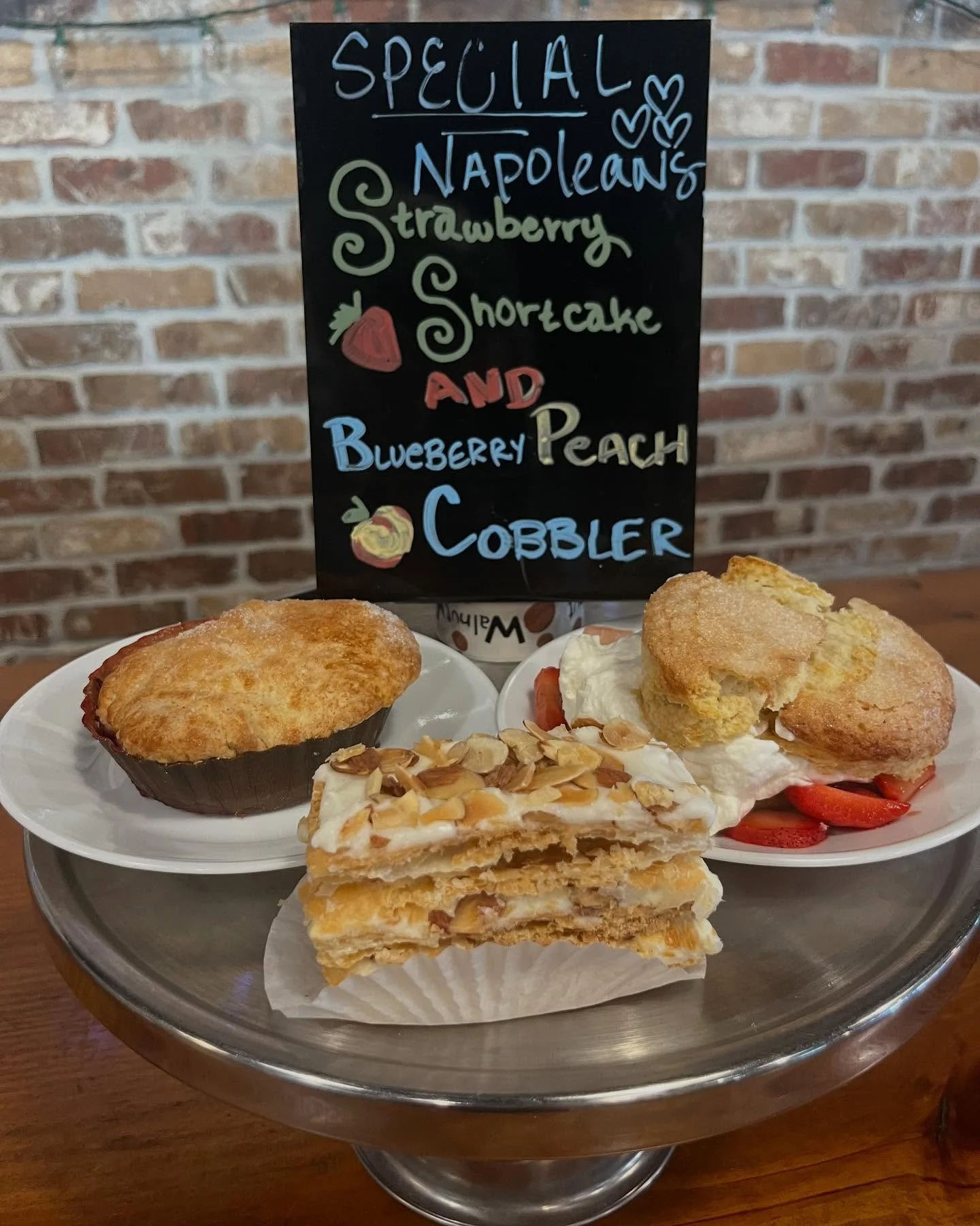 Come in for a tasty Mother&rsquo;s Day treat! Fresh and local strawberry&rsquo;s in the strawberry shortcake and fresh and local peaches in the peach blueberry cobbler! #mothersday #specials #fairhopealabama #warehousebakeryanddonuts