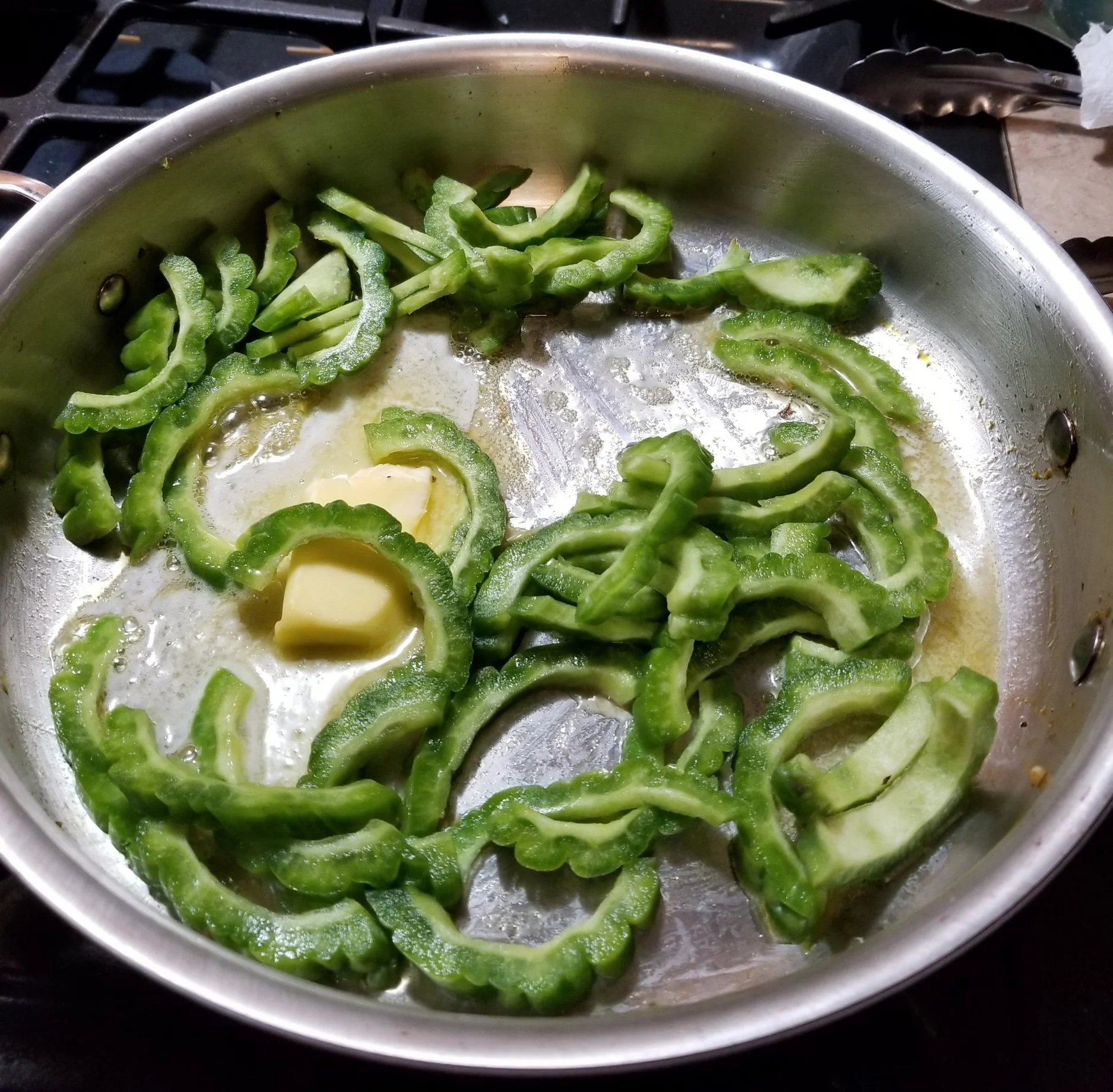 Bittermelon and butter sautéing on medium heat.