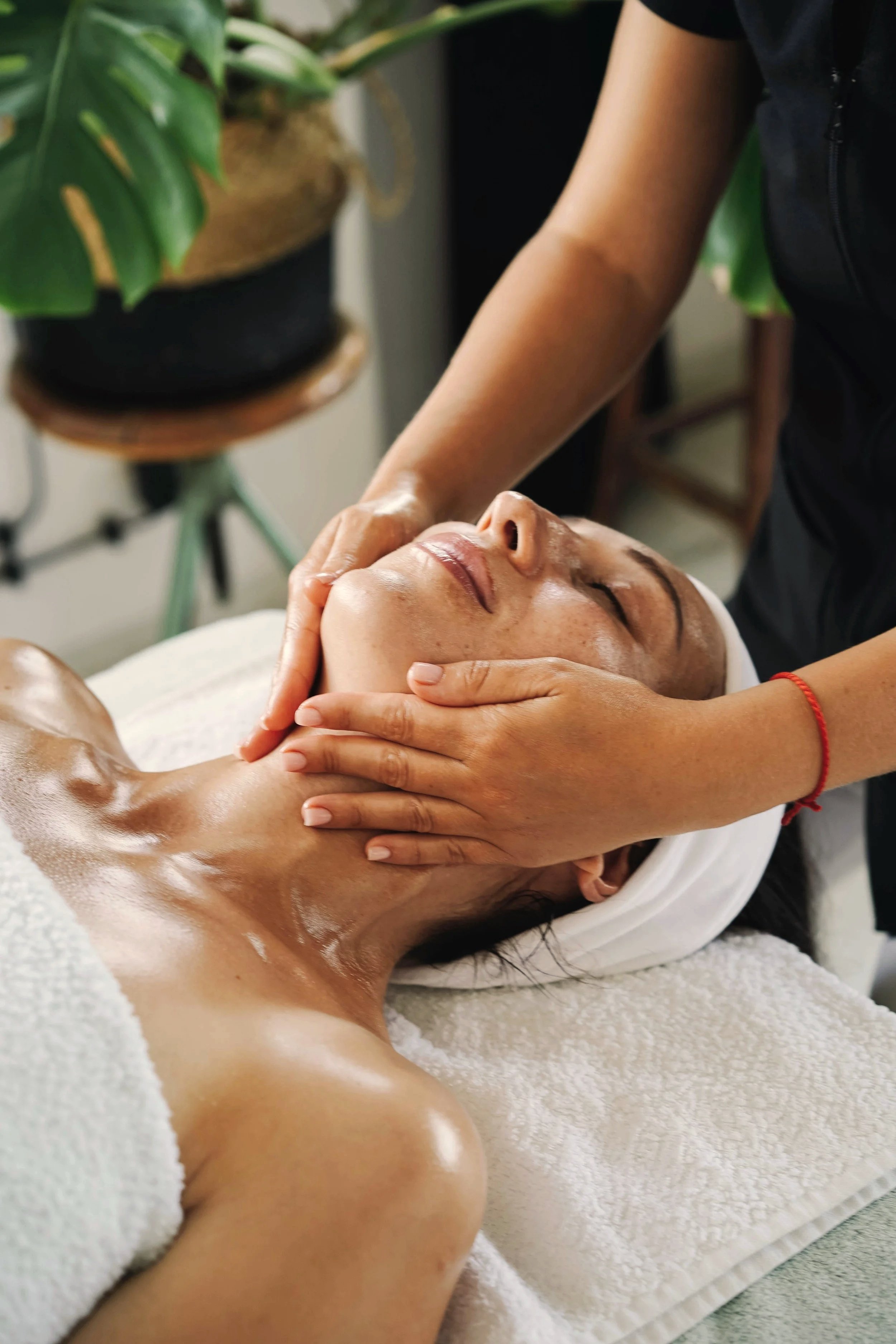 Person applying hand sanitizer from a white pump bottle onto their hand.