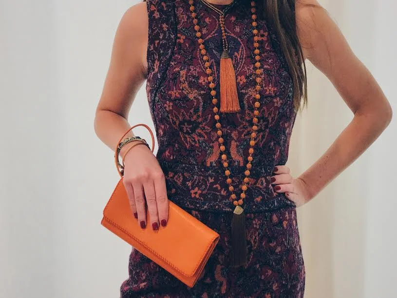 Our textile-inspired knit dress brings the style of Cuban architecture into a practical lifestyle. Want to accentuate tropical flare? Pair with our beaded tassel necklaces, inspired with native orange beads. A complimentary orange wallet further emphasizes the bright orange color so commonly associated with Cuban flare. 