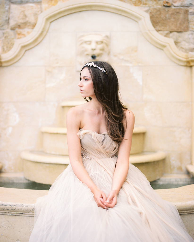 Bride in Samuelle Couture Wedding Gown Sitting on Fountain 