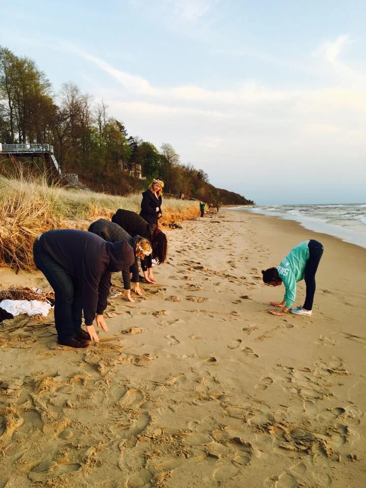 Jessica teaching Yoga on the beach to a bunch of people whose sobriety is questionable.