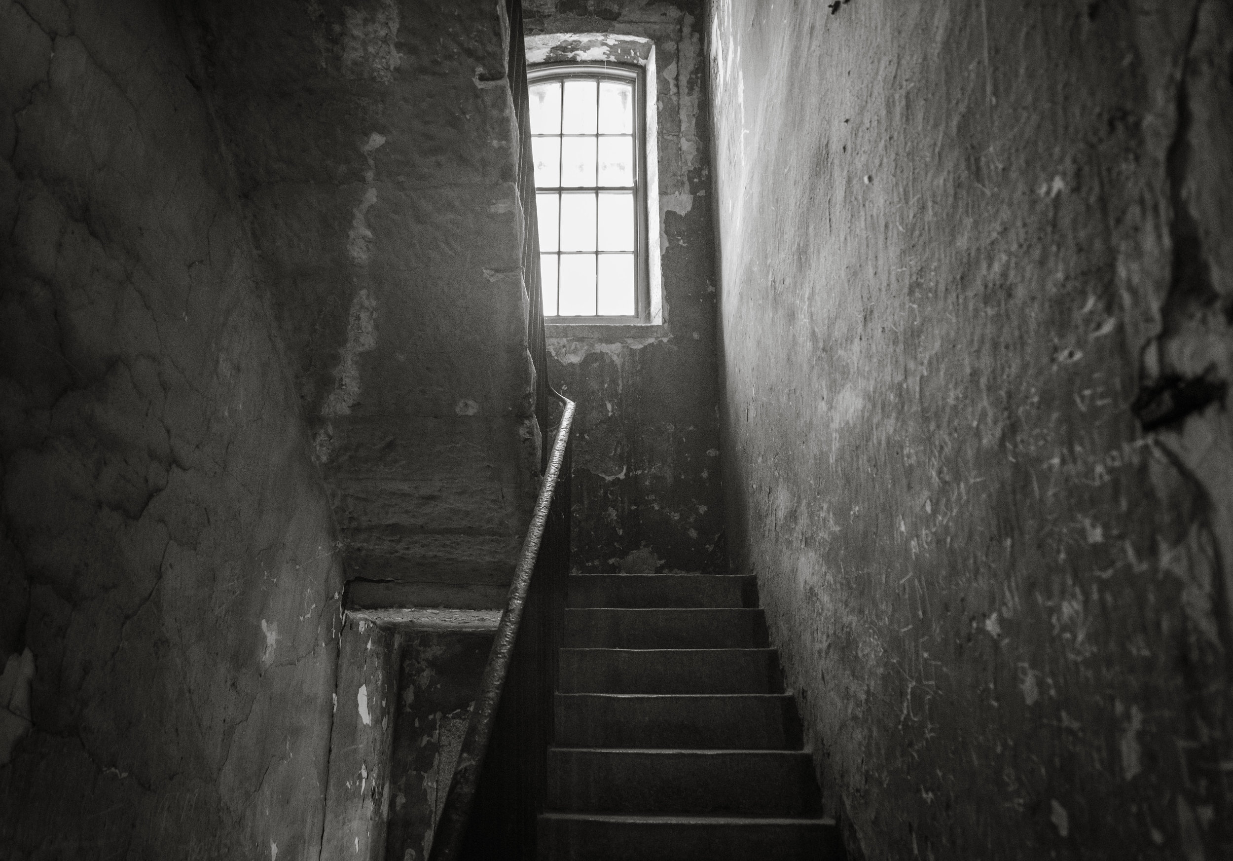 We took a staircase down one level. They were uneven and worn. 