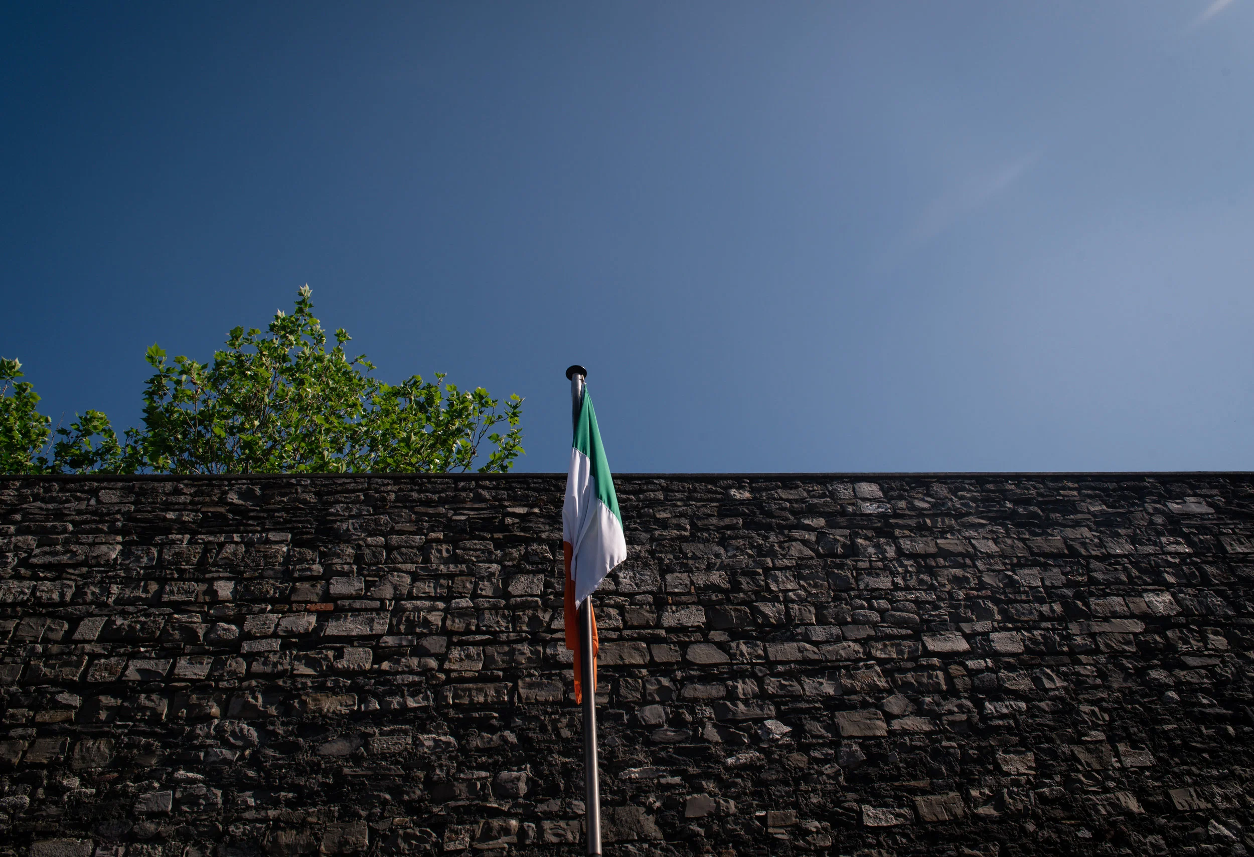 The Irish Tricolor stands in the middle of the courtyard. 