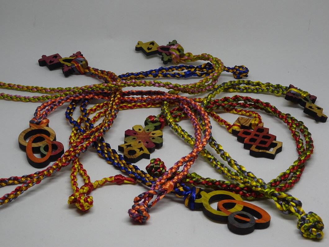 olive-wood-pendants-on-colorful-kumihimo-braids.jpg