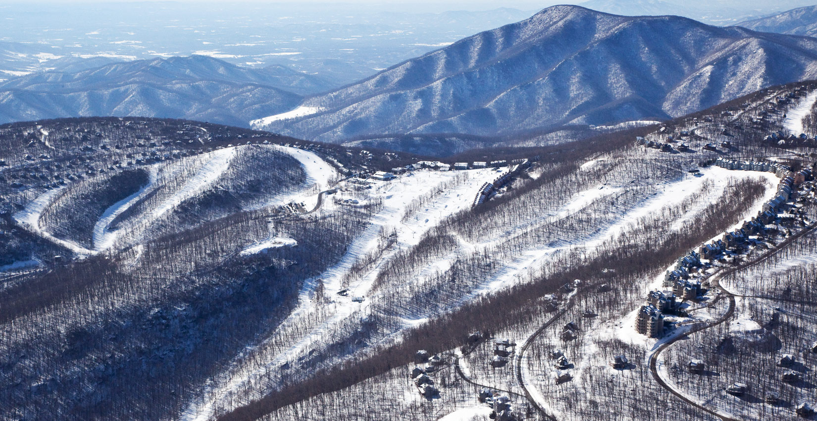 Wintergreen Resort's slopes offer something for both black diamond fans and tiny tots. The snowboarding park is served by a six-seat high-speed lift. There is ice skating . The new, multi-million-gallon snowmaking system ensures the grins keep coming. Check it out .