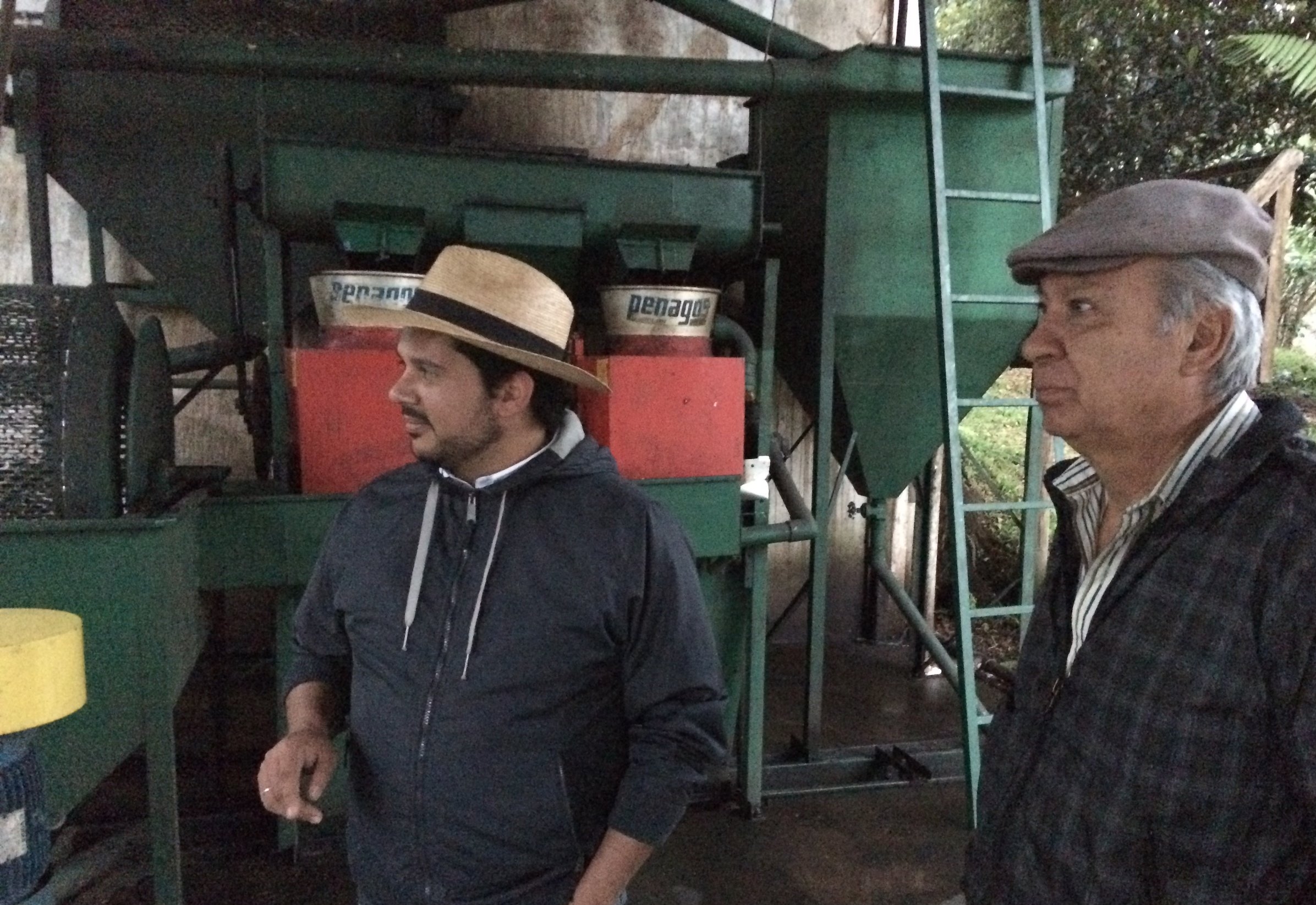 Josué Morales (left), our partner at TG Lab, stands with Don Carlos, the manager of Fátima, in front of the farm’s tiny onsite mill.