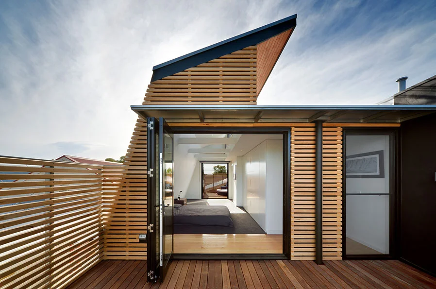 secluded, private balcony off a bedroom, clad in timber battens